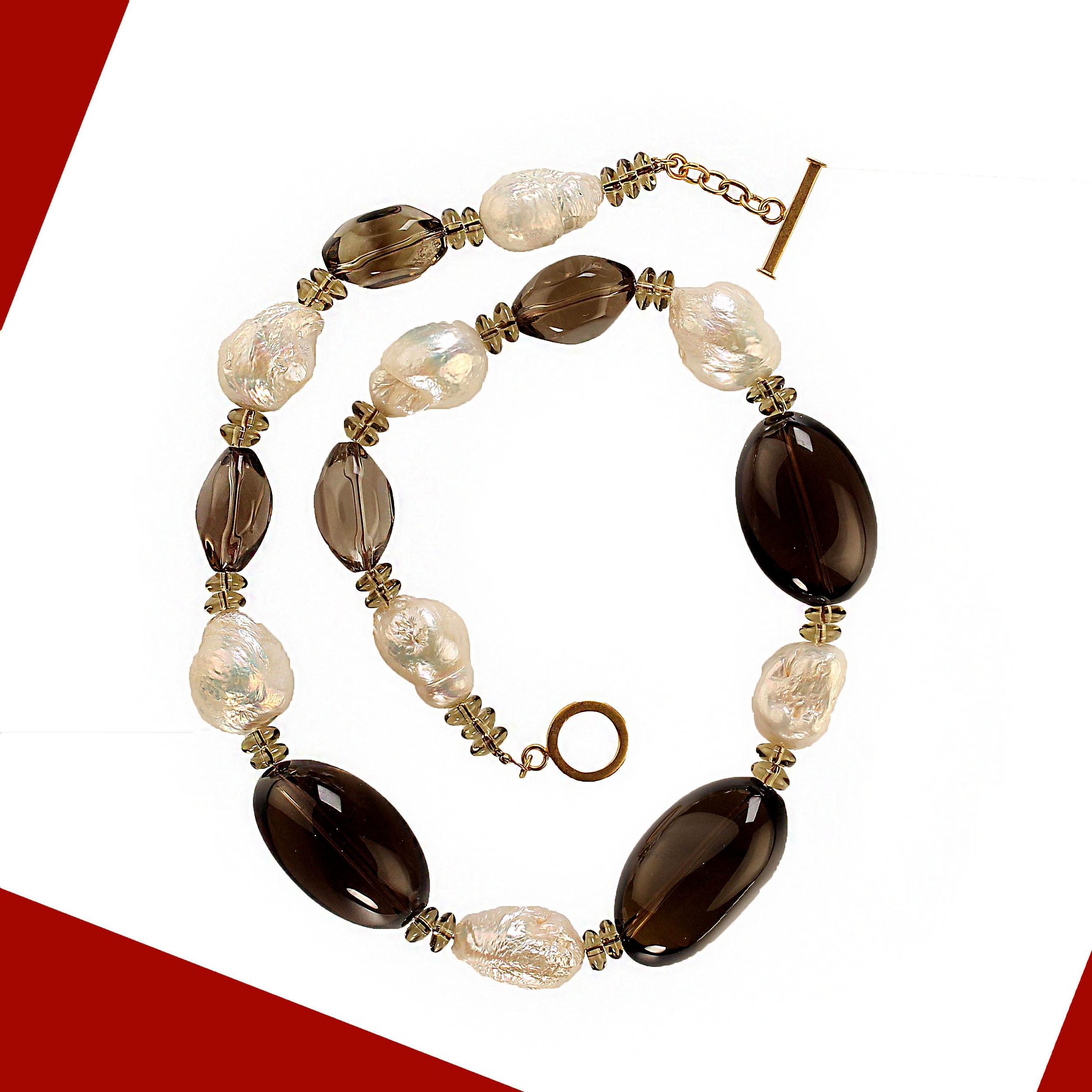 Necklace of iridescent white Pearls mixed with various sizes of Smoky Quartz. These Pearls are freeform and 18-22 mm in size. There are three large puffy Smoky Quartz nuggets, four softly faceted transparent Smokies, and lots of sparkling