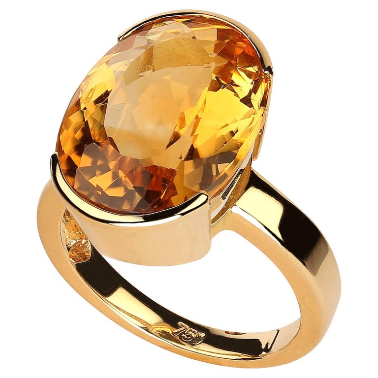 Elegant 18K yellow gold and oval Brazilian Citrine ring. This stunning one of a kind ring is sure to become your 'go to' hand candy. The rich yellow 18K gold and the honey gold of this 10.31 carat oval Citrine combine perfectly. There is nothing