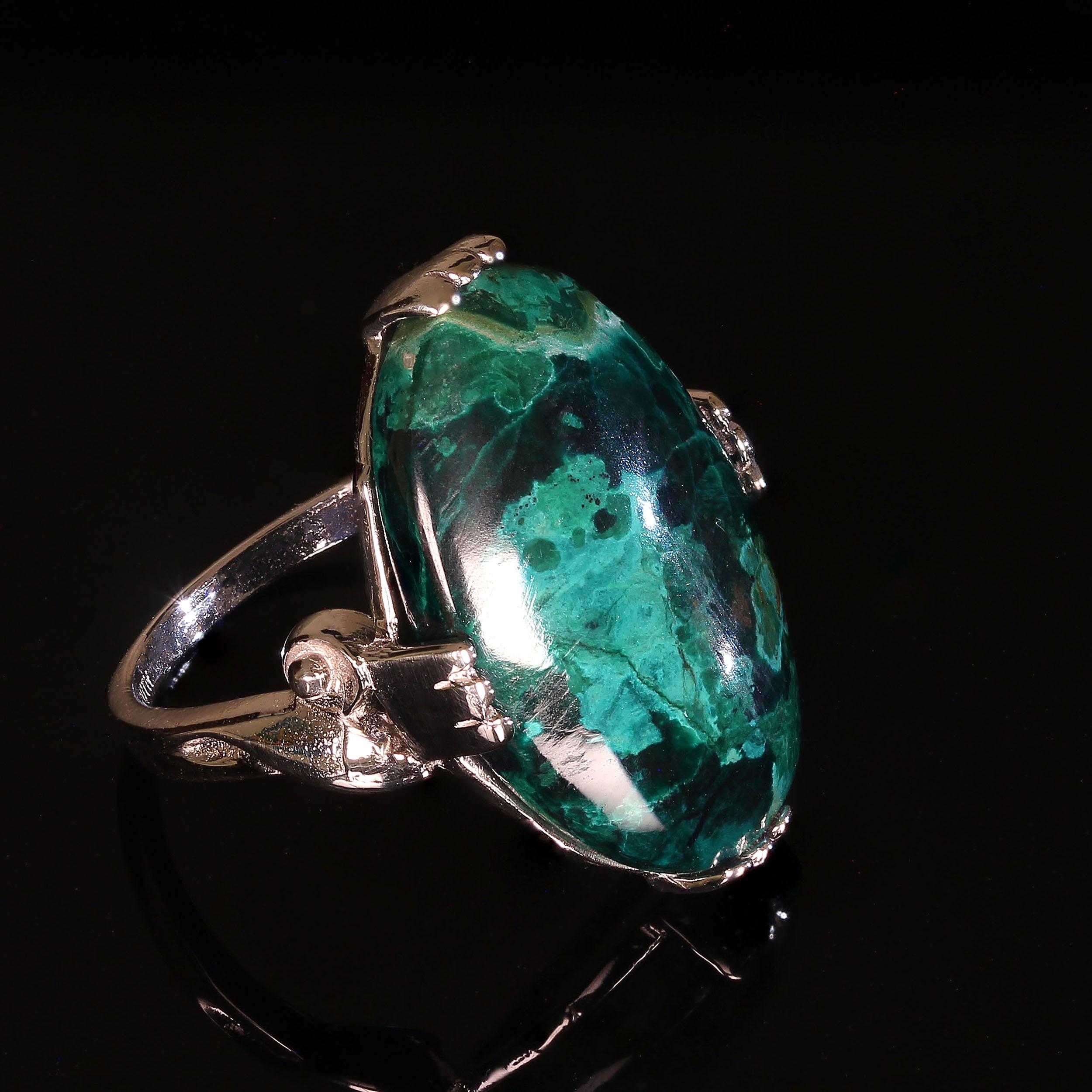 Elegant Chrysocolla Cabochon Ring of 14K White Gold. This 12.58 carat oval gemstone is as beautiful as they come, greens, verging on blue swirls with black. All of this in a 14K white gold setting made especially for this gemstone.  This is a
