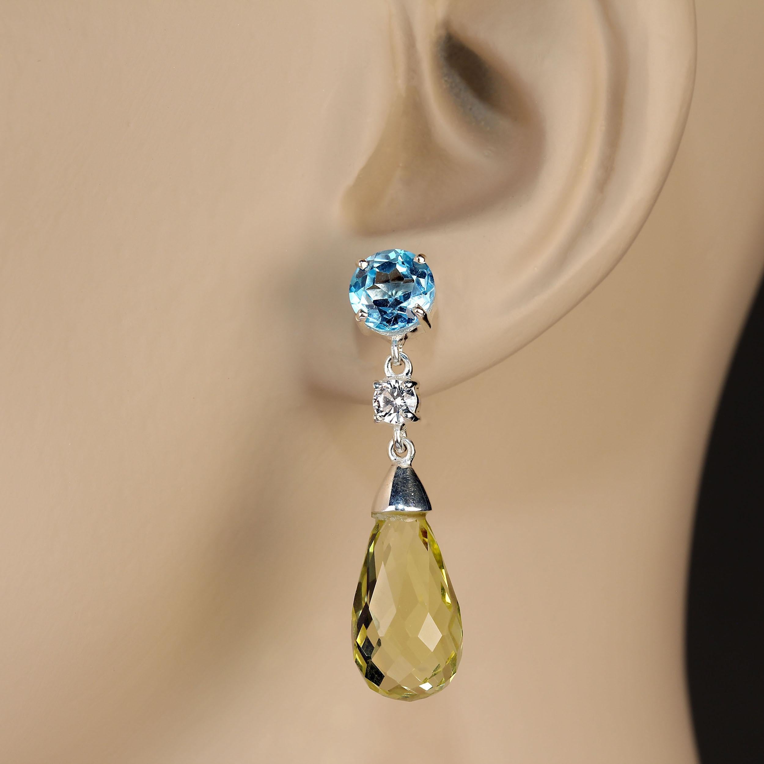 Elegant dangle Lemon Quartz and Blue Topaz in Sterling Silver Earrings. These lovely long drop Lemon Quartz briolettes weigh 17.28ctw.  The 7mm round sparkling Blue Topaz weigh 3.44 ctw.  The total drop is 1 3/8 inches. The two gemstones are