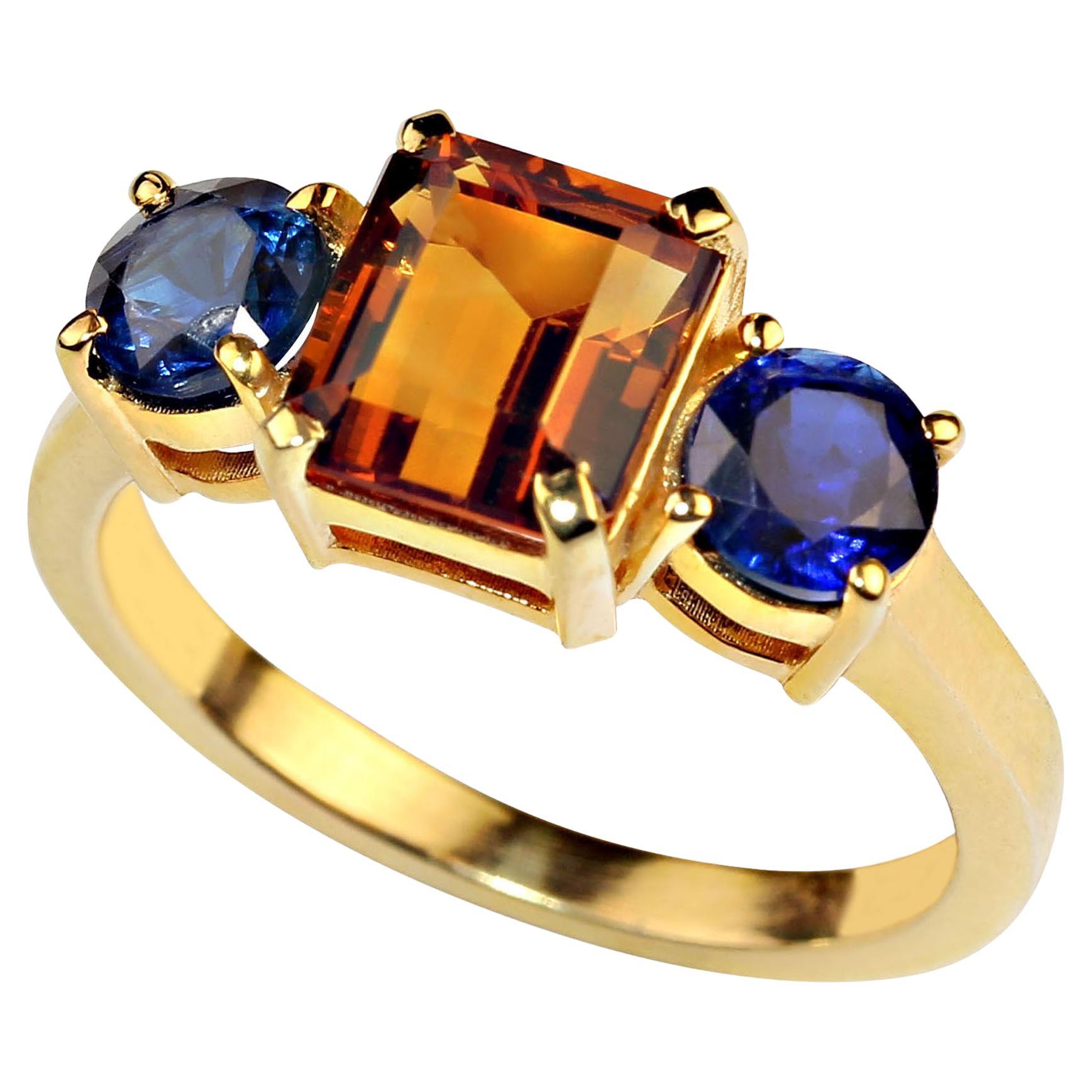 This classic three stone ring is set with an elegant combination of rich Citrine and Kyanite. This emerald cut Citrine weighs 2.05ct. The two blue Kyanite weigh 1.41ctw. In ancient times people carried Citrine as a protection against evil thoughts