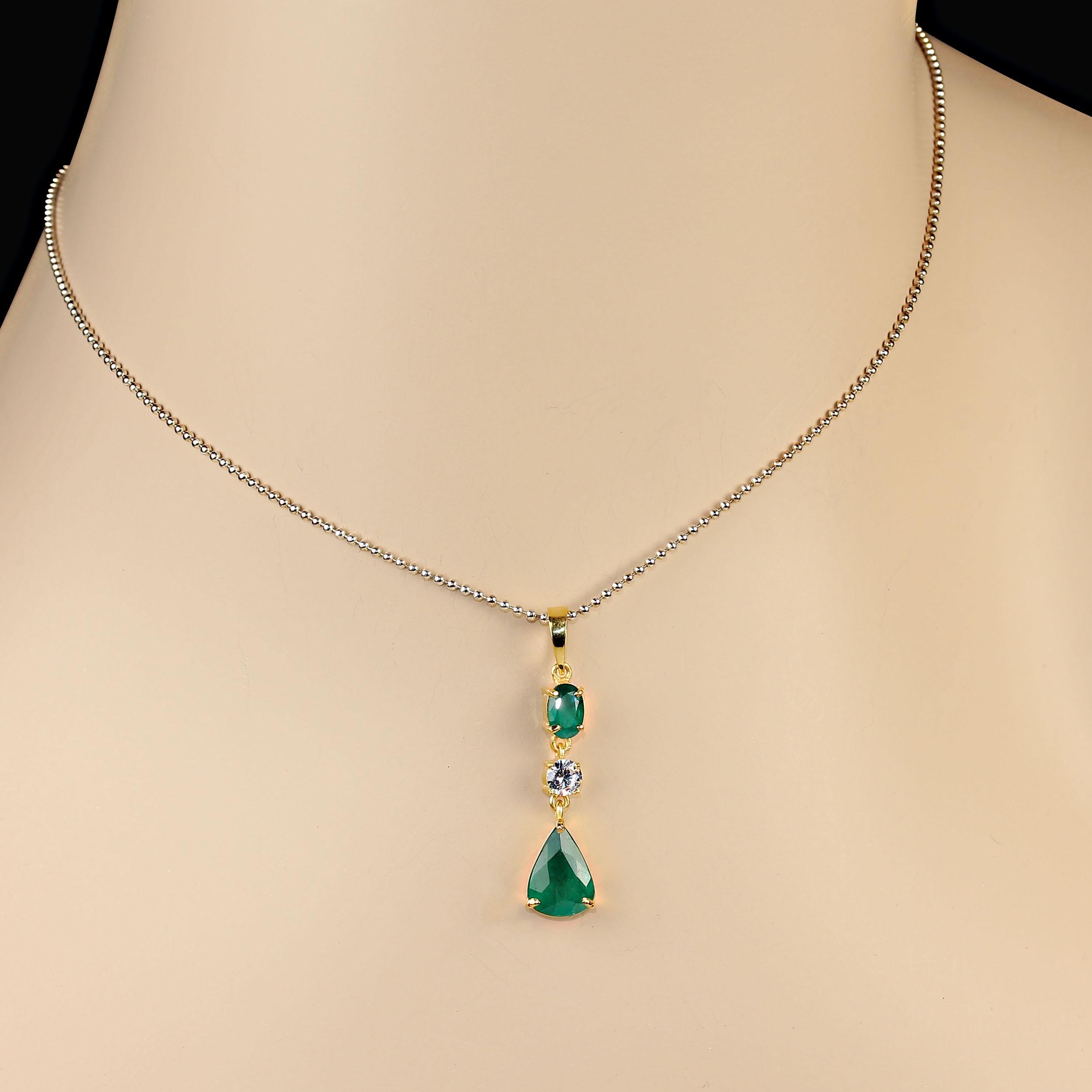 Elegant Emerald pendant features to gorgeous emeralds. Wear this beautiful 1 3/8 inch pendant with all your favorite outfits.  These emeralds total 2.01 carats and are accents with a 0.20ct genuine white zircon.  These emeralds are a lovely deep