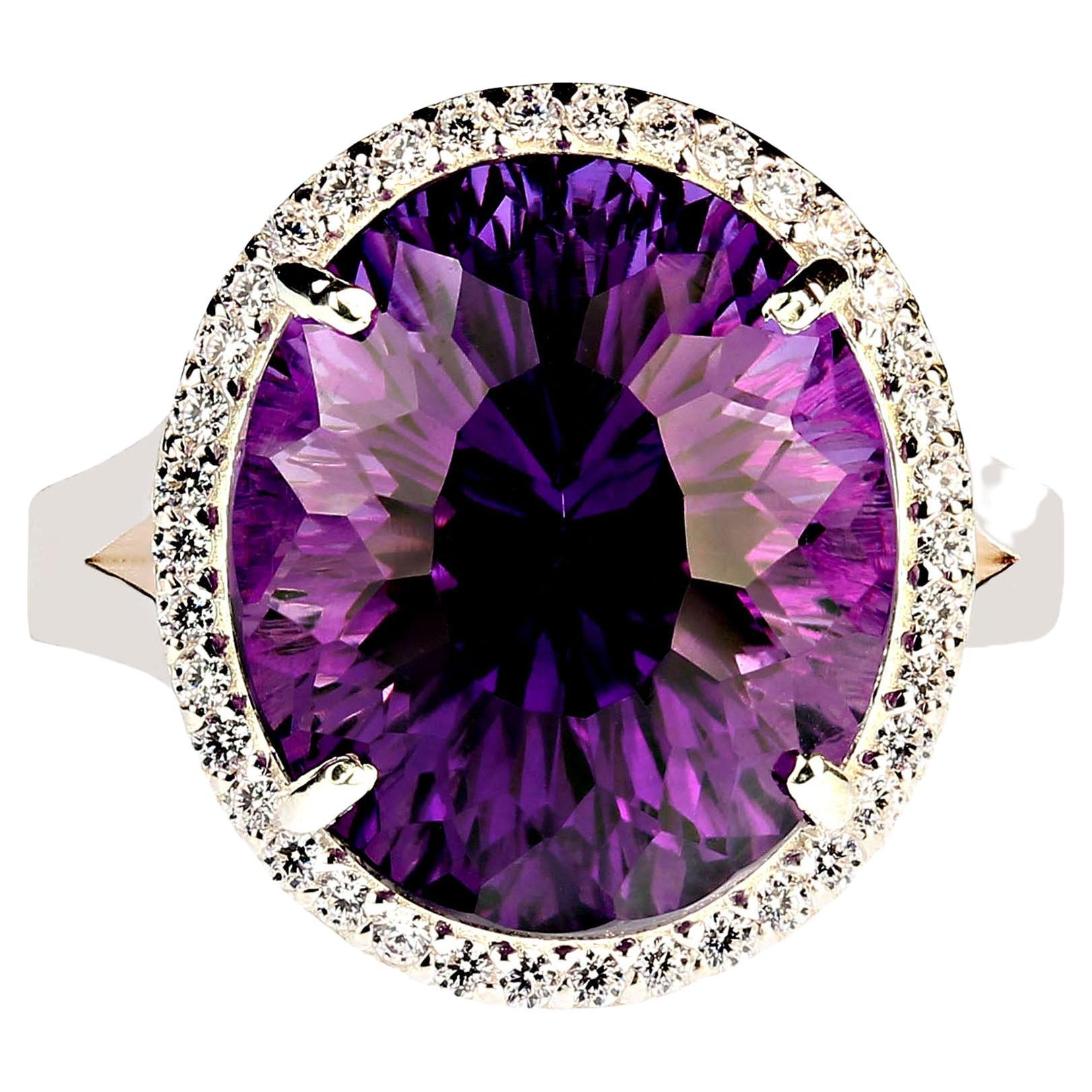 Elegant Evening Cocktail Ring of oval Amethyst, 12.40ct, surrounded by sparkling genuine zircons, 0.57ct.  This unique amethyst is a special cut with extra sparkle and flashes of pink in the purple.  The setting is sterling silver featuring a lovely