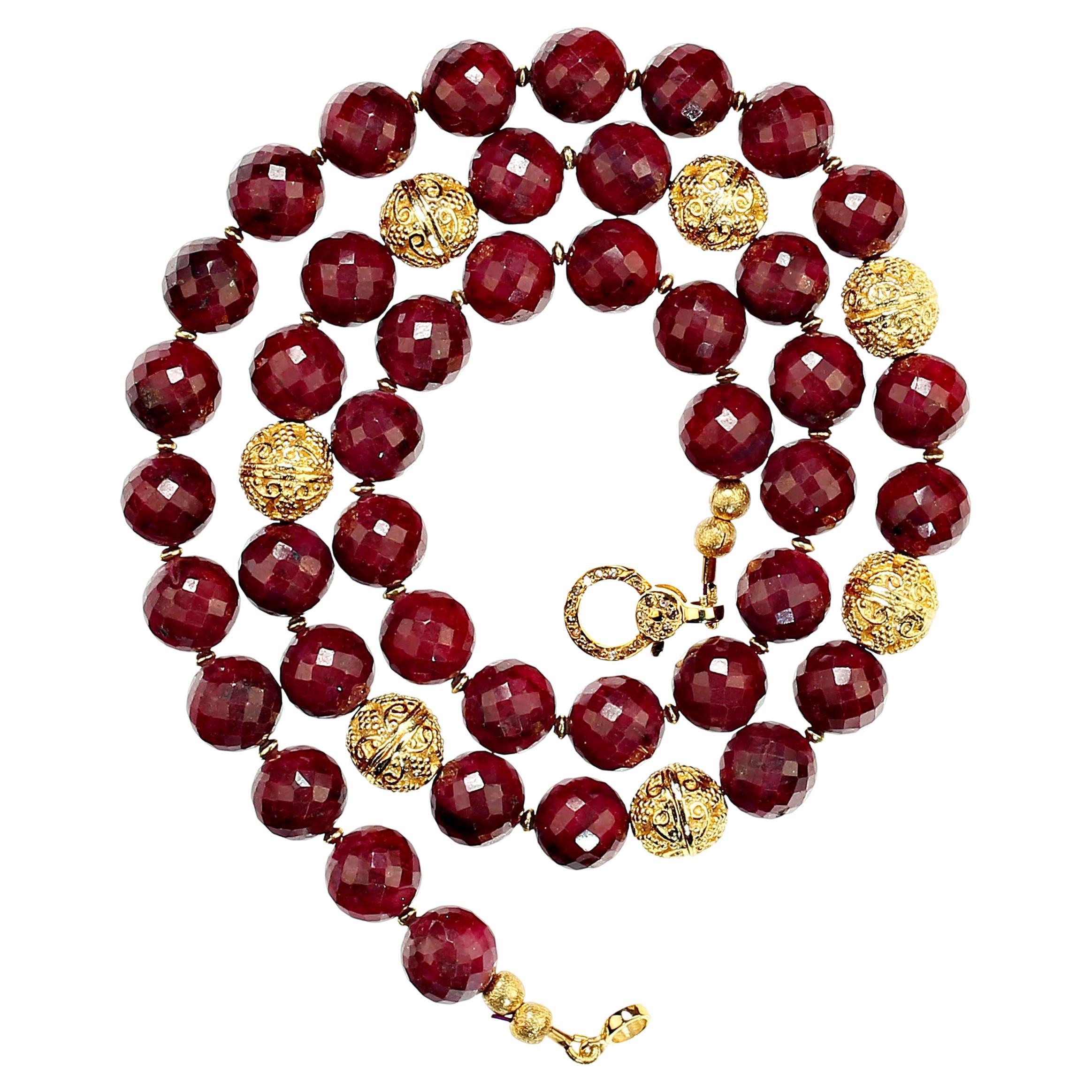 21 Inch necklace of faceted ruby, 9.5mm, with goldy accents.  The gorgeous necklace is just perfect for all you RUBY lovers. These lovely gems are secured with a gold vermeil clasp sparkling with diamonds. MN2308