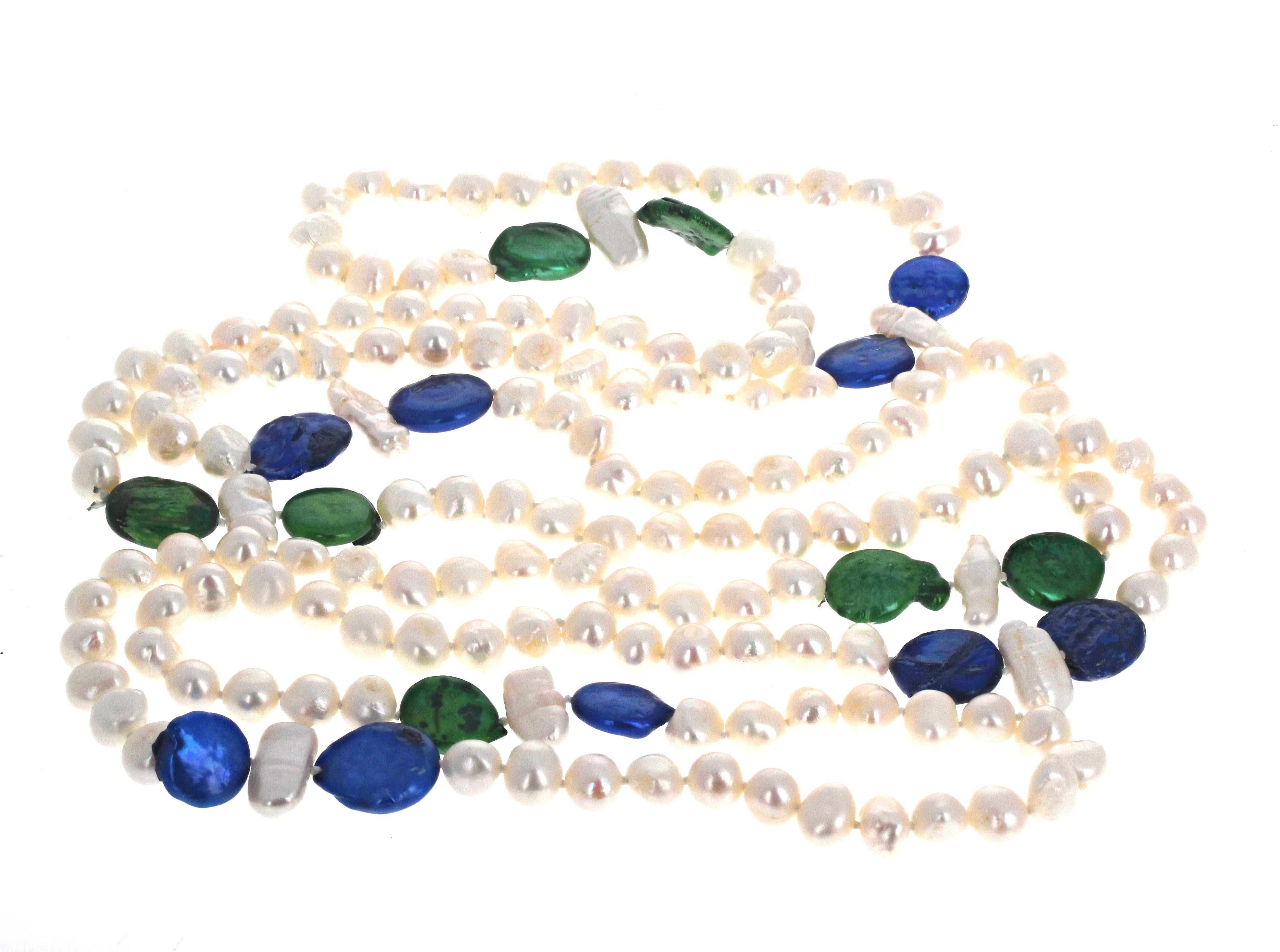 This gorgeous 73 inches long necklace is composed of white real Pearls of slightly different shapes and sizes (most about 10mm).  The Blue and Green Pearls are colored Pearls but glow beautifully.  This can go easily 3 times around your neck and