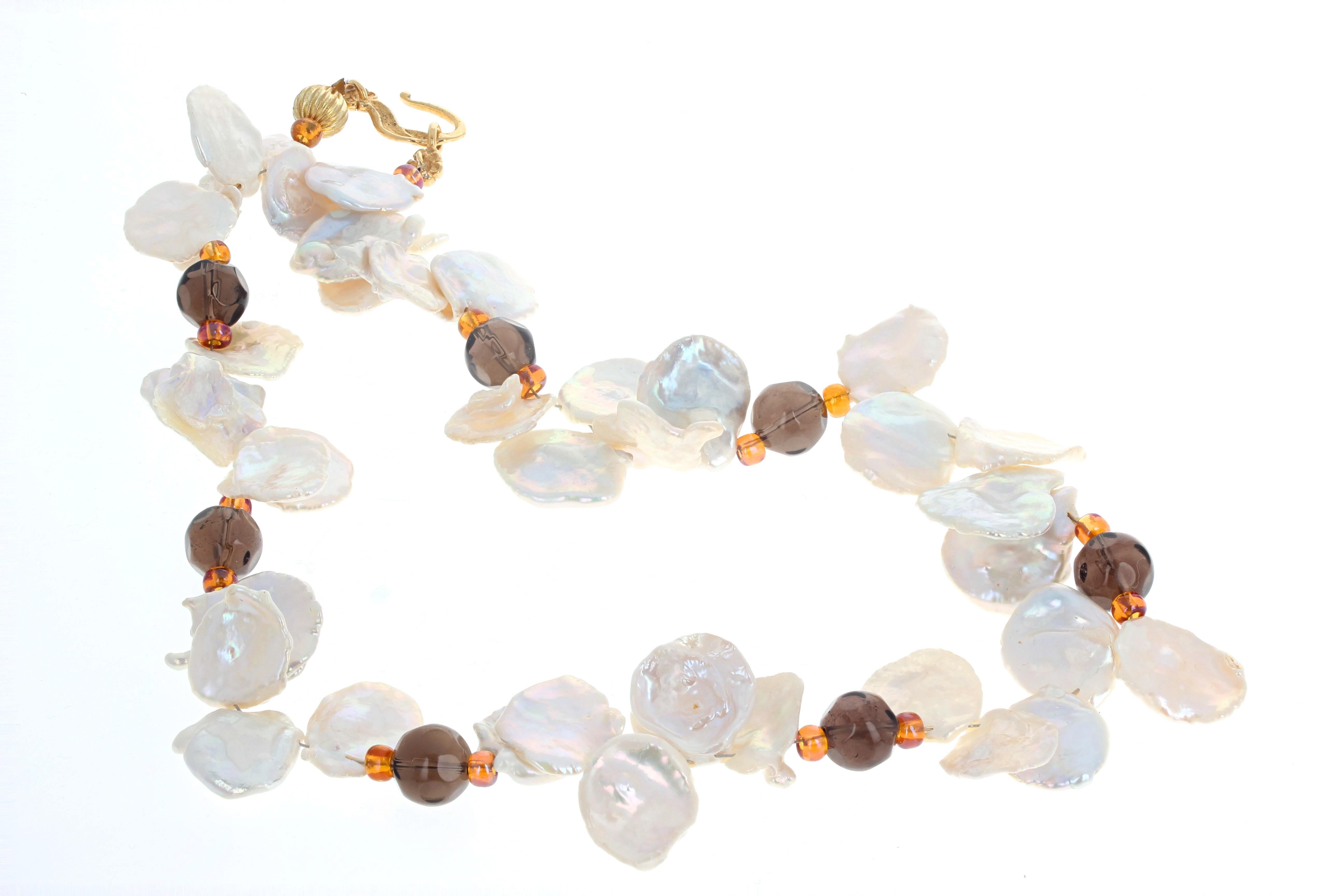 This elegant necklace of beautiful natural white glowing Keshi Pearls is enhanced with gem cut and highly polished natural real gem cut big Smoky Quartz rondels. The largest Pearls are approximately 19mm and the Smoky Quartz are 10mm.  The clasp is