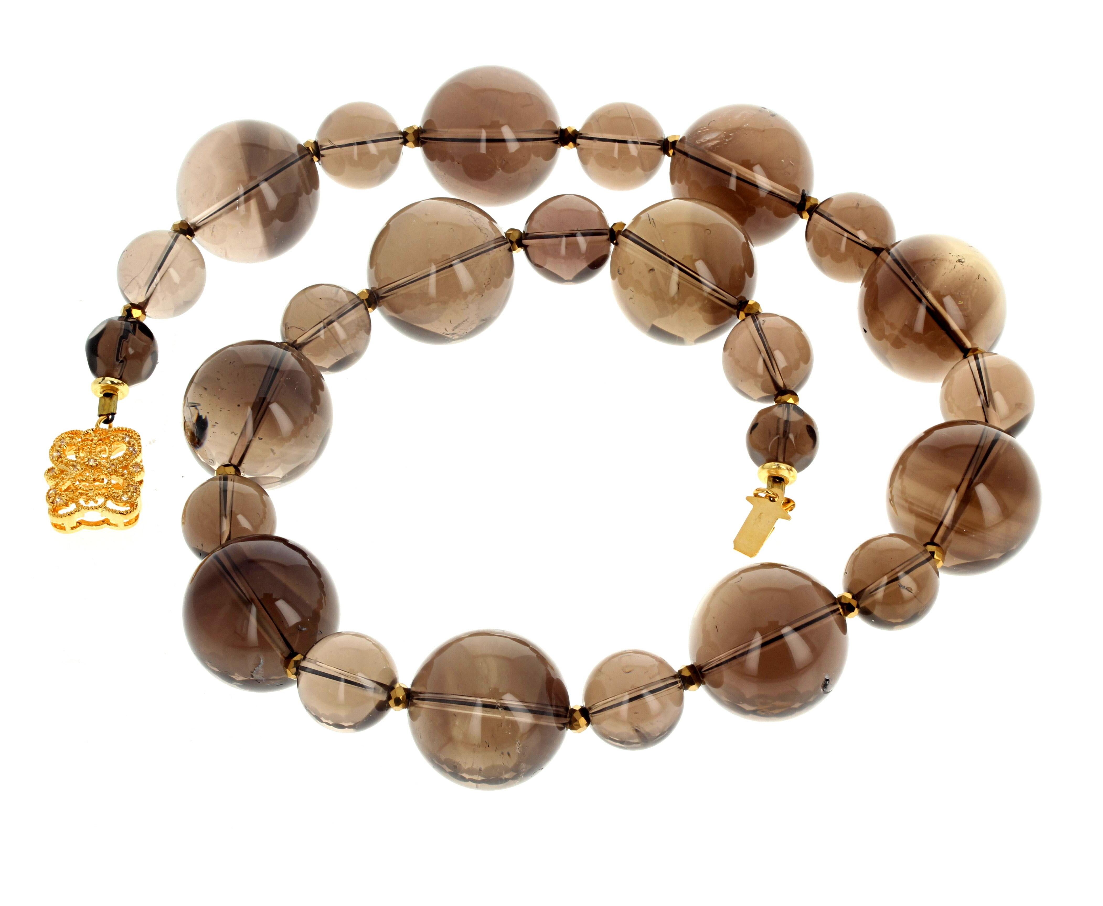 Fascinating large natural real Smoky Quartz - the largest approximately 20MM and the smaller ones approximately 13mm - in the beautiful 18 inch long necklace.  The clasp is an easy to use gold plated slide-in clasp.  