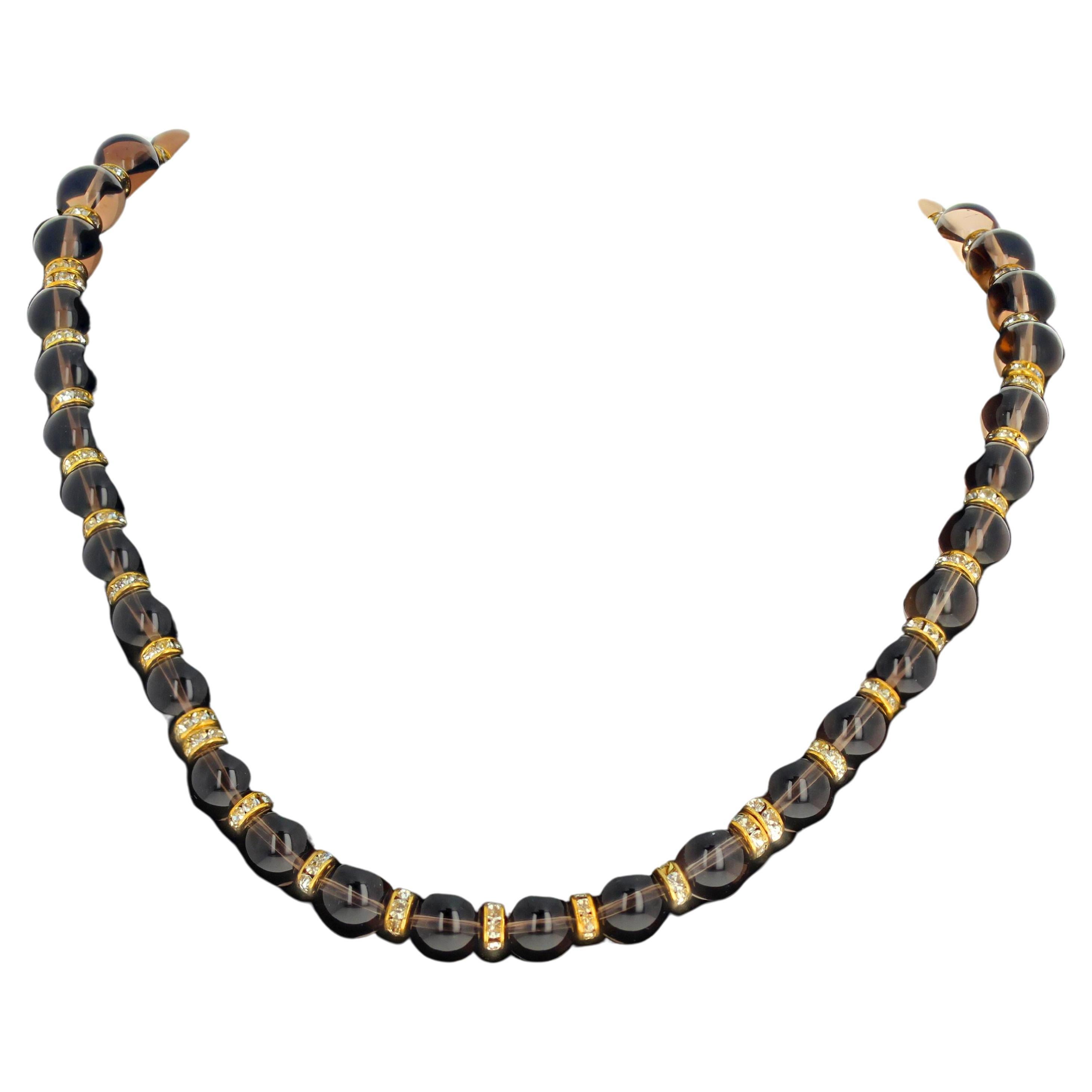This beautiful outstanding necklace of natural real Smoky Quartz is enhanced with sparkling gold plated spacers.  The Smoky Quartz are highly polished glowing approximately 10mm.  The clasp is an easy to use toggle clasp.  This is lovely to wear on