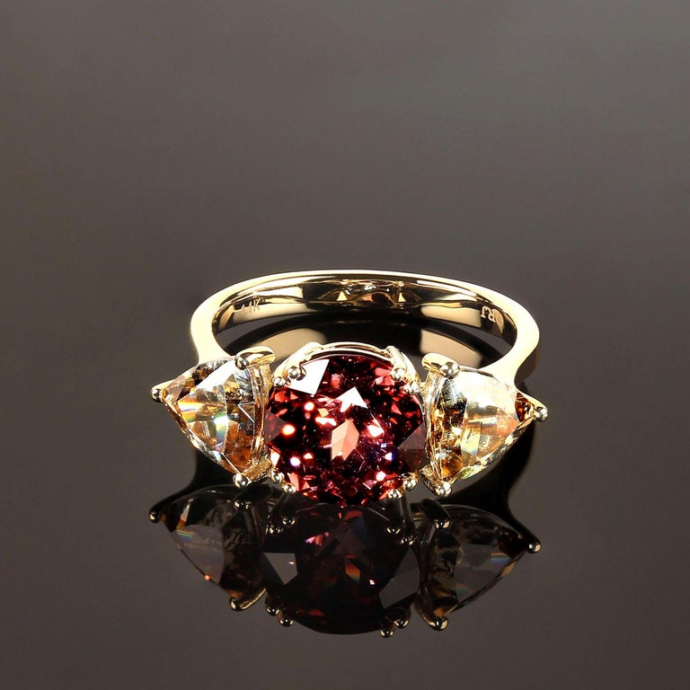 Custom made stunning original 14K Yellow gold ring featuring natural red and smoky toned Cambodian zircons. Sizable 7. These rich colors are further enhanced by the natural brilliance of genuine zircons. The red round center gemstone is 4.28 carats.