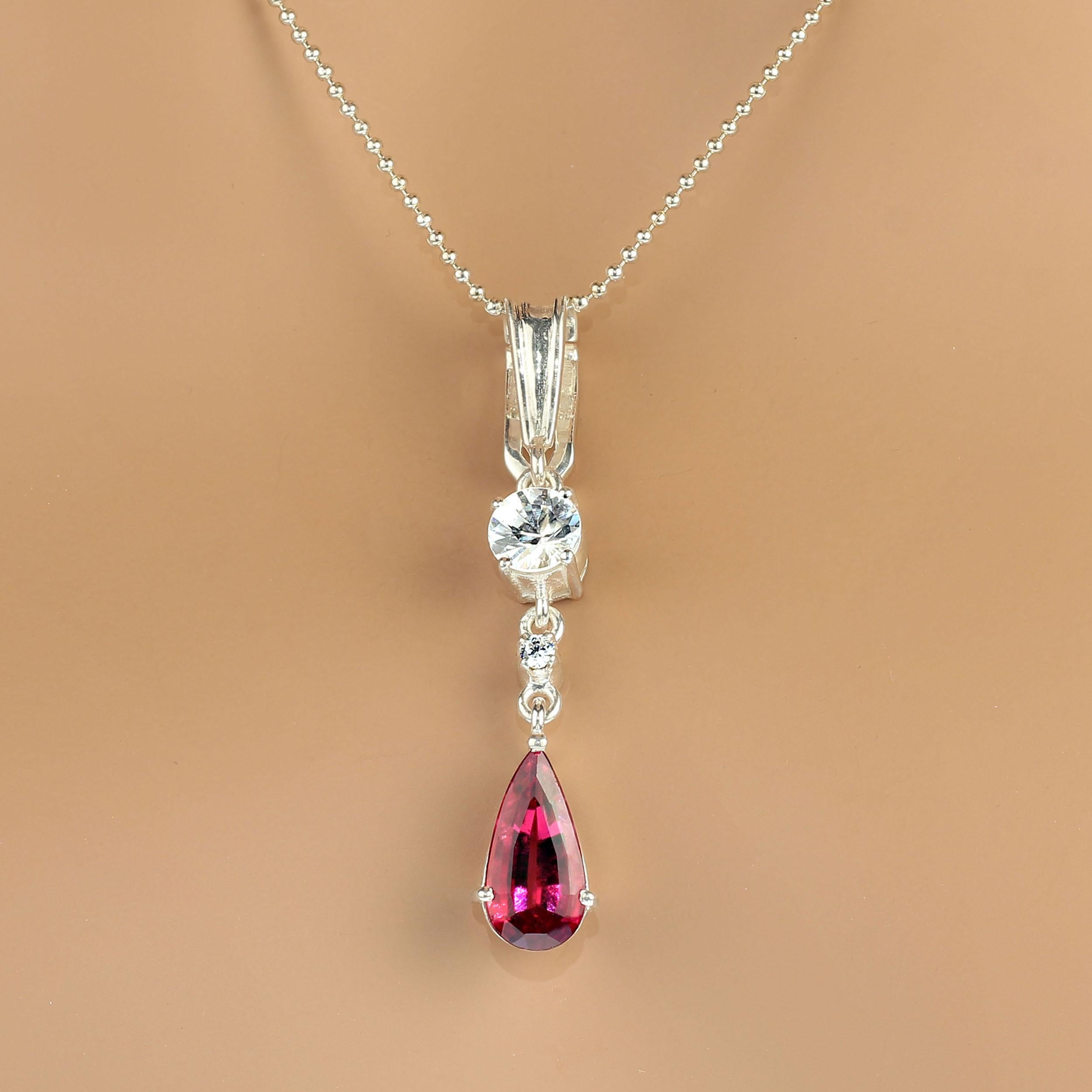 Lovely, long pendant of 1.75 inches in glowing rubelite and sparkling genuine zircon.  This gorgeous teardrop shaped rubelite is from one of our favorite vendors in the mountains outside of Rio de Janeiro. We've paired it with sparkling genuine real