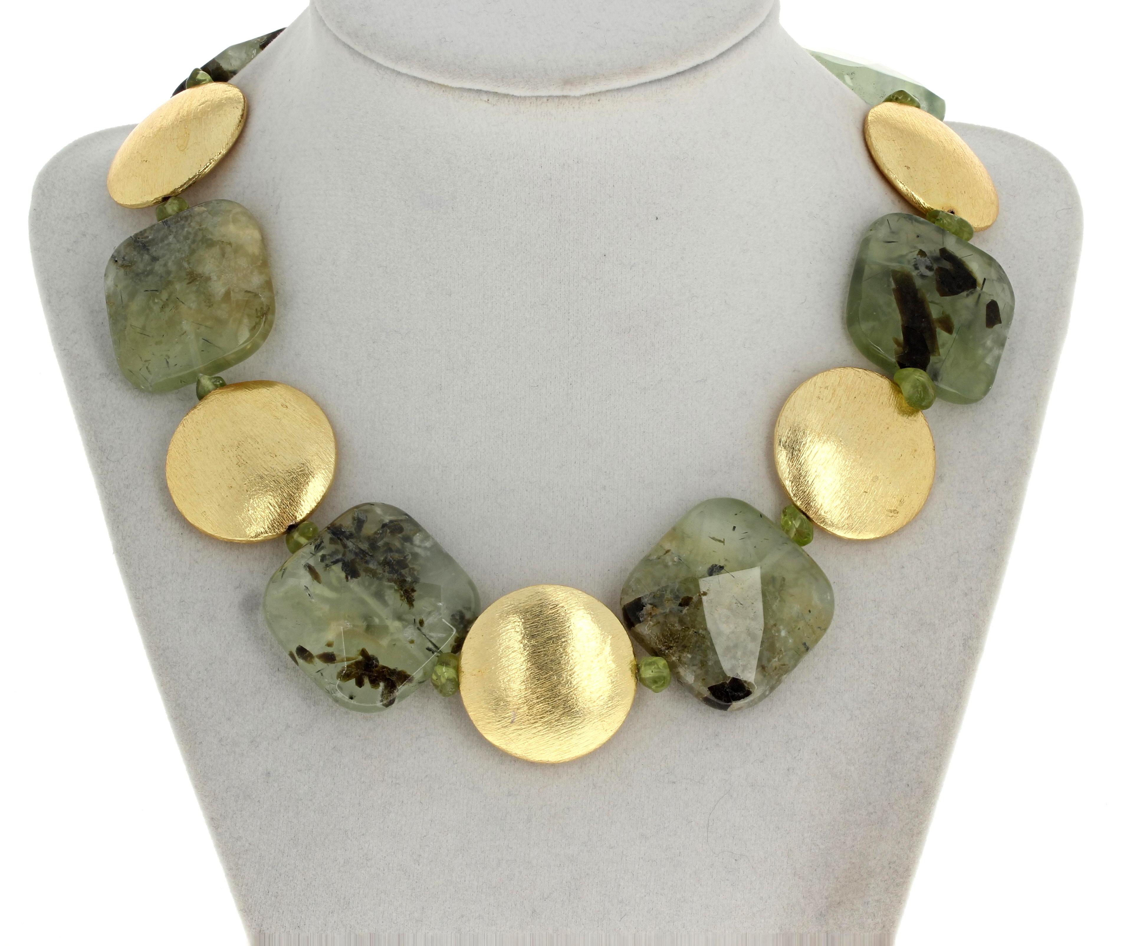 This elegant single strand of gemcut natural green Prehnites (each approximately 30 mm x 30 mm) is enhanced by 28mm gold plated rondels and teeny tiny little polished Peridot chips.  This is 17 1/2 inches long and the gold plated clasp contains a