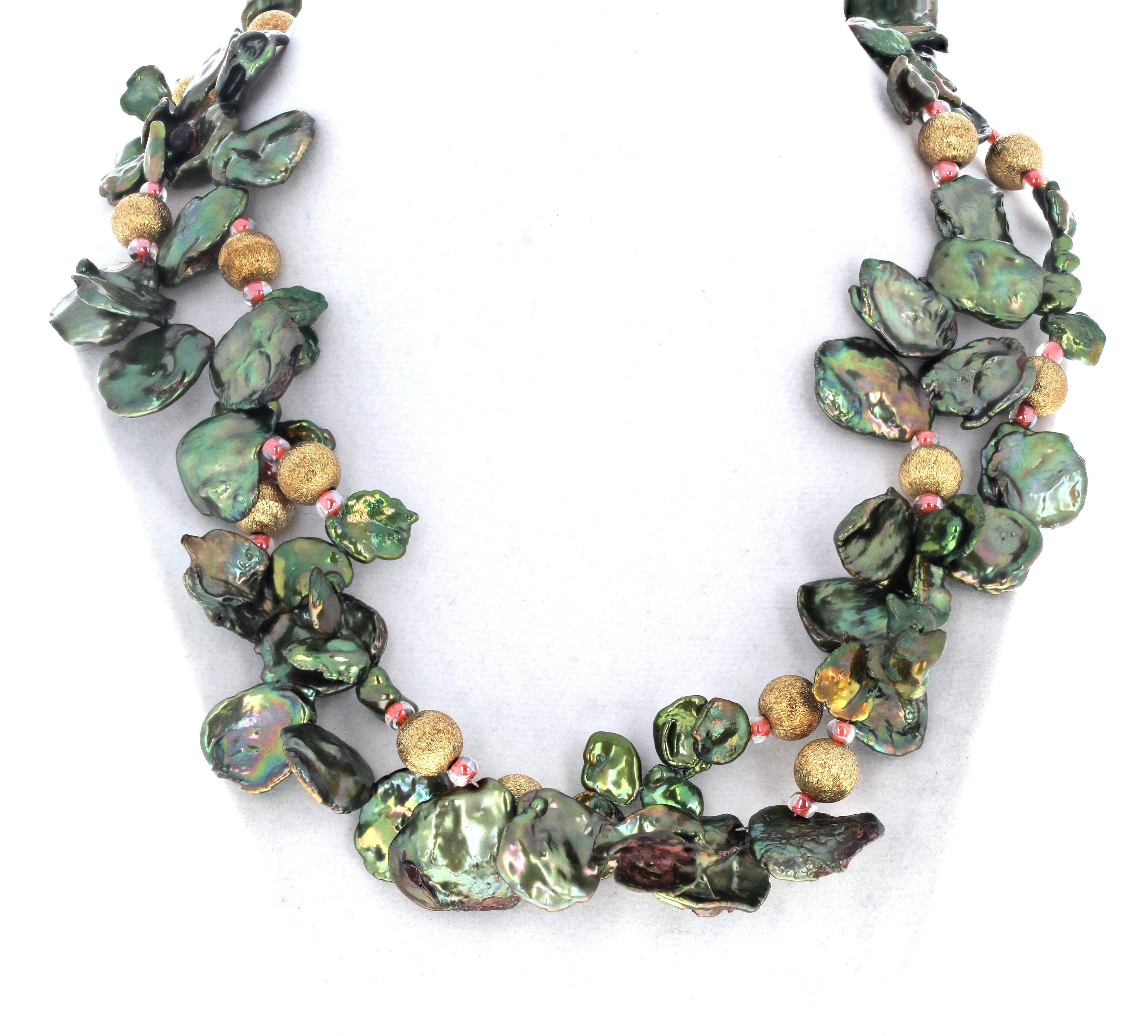 These flip-flop real Pearls are enhanced with little gold plated 10mm round rondels The Pearls are approximately 16mm.  The necklace is 19 inches long and the clasp is an easy to use gold plated hook clasp. This is much prettier around your neck