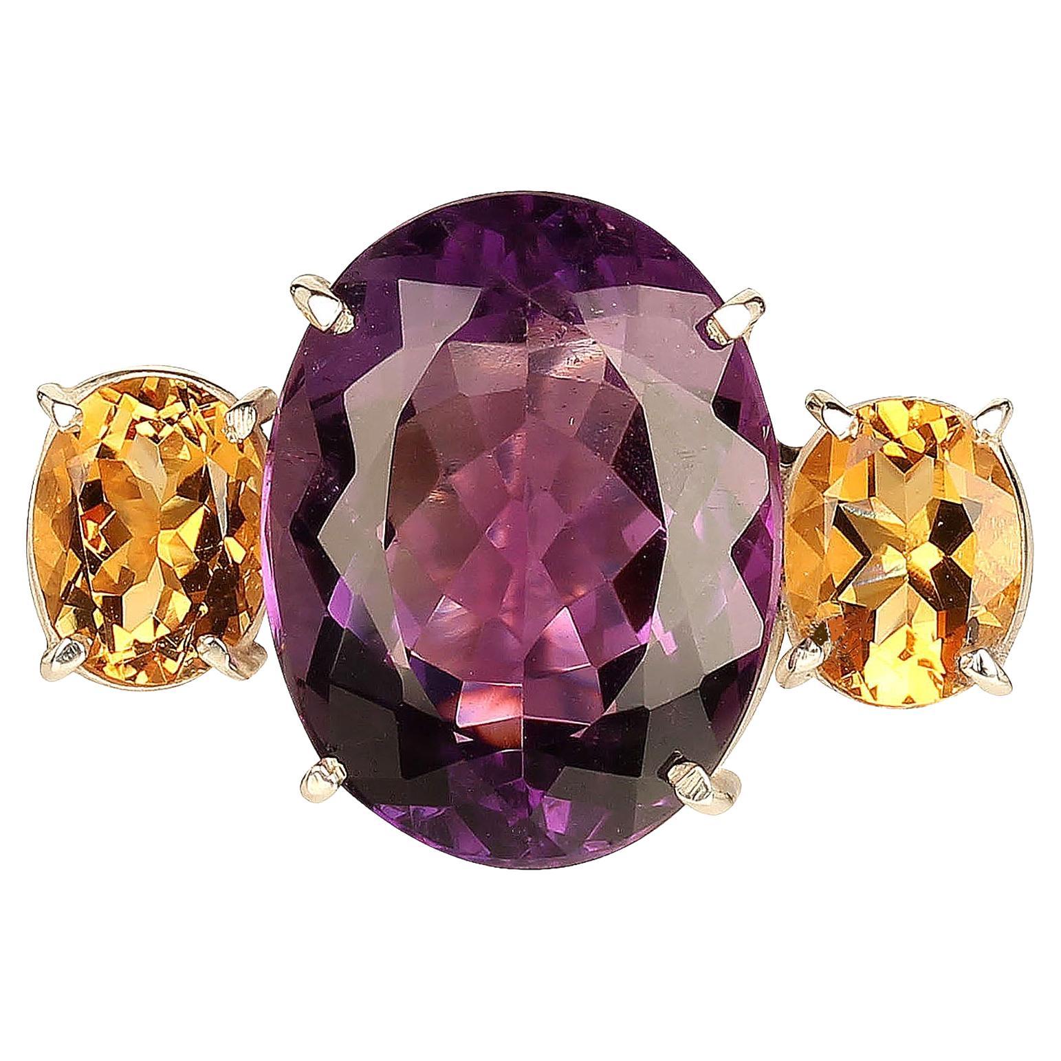 Sparkling oval Amethyst (approximately 18ct) accented with two oval brilliant Citrines in handmade Sterling Silver setting from one of our favorite Brazilian vendors. 
Amethyst is the February birthstone and is said to protect from intoxication and