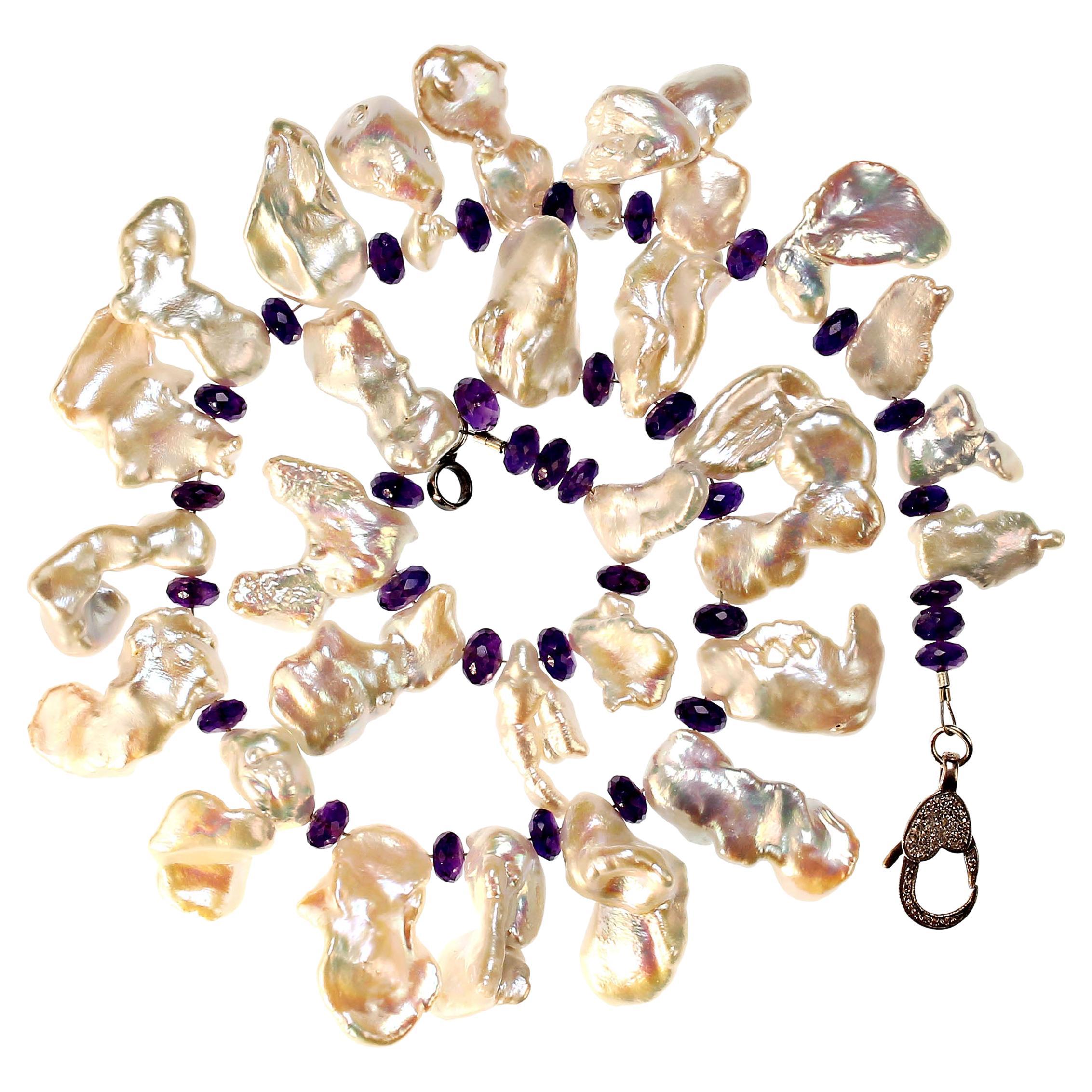 Own the jewelry you wish for

Delightful, custom made necklace of free form iridescent Pearls and sparkling Amethyst rondelles.  The pearls are gently graduated from 17x8 mm to 23x12 mm.  The amethyst is 6 mm. This lovely 17 inch necklace combines