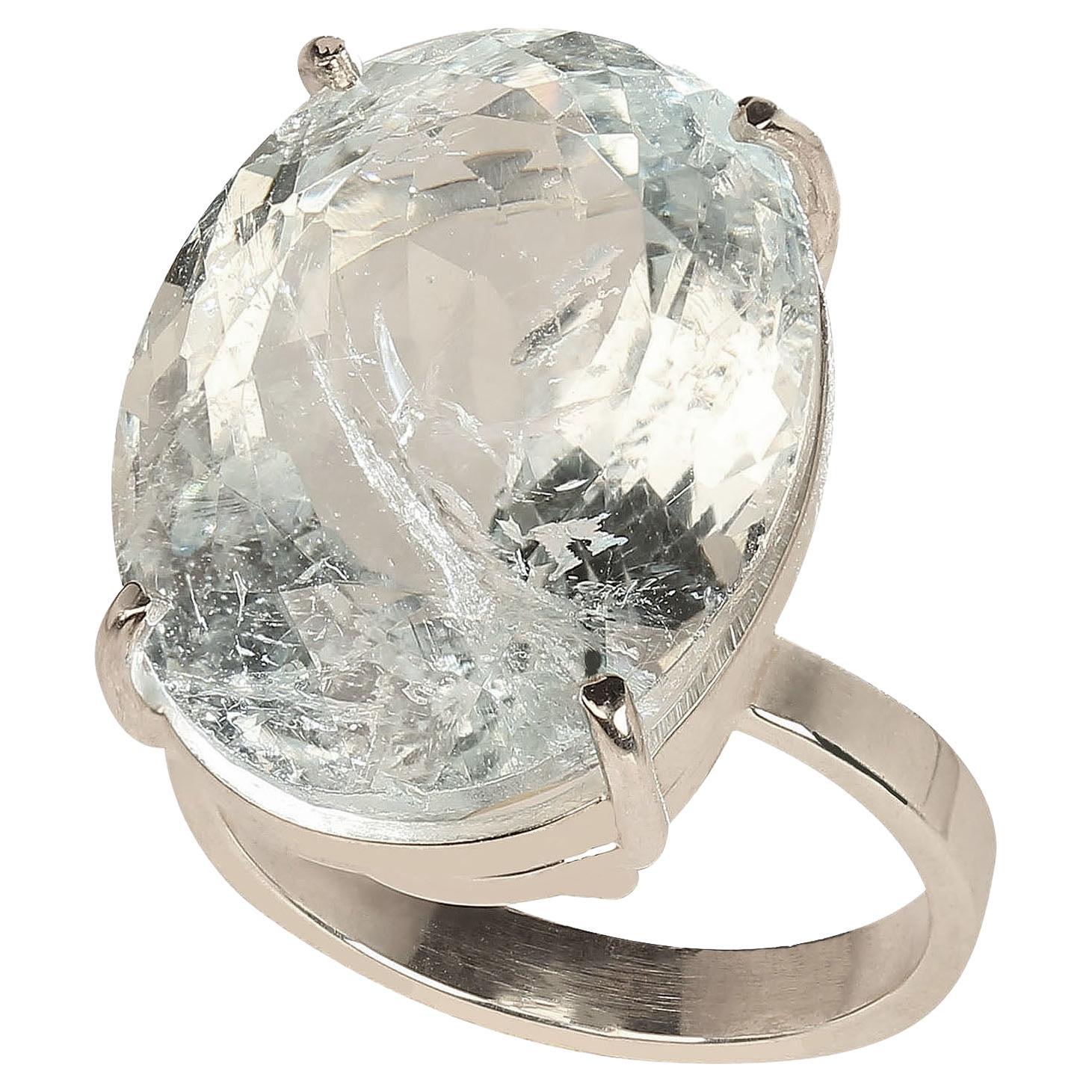 Glittering, oval 23 carat Aquamarine ring. This stunning ring comes straight from our favorite vendor in Belo Horizonte, Minas Gerais, Brazil. He mines his gemstones from his own aquamarine mine, and then has the rough cut and faceted.  We discuss