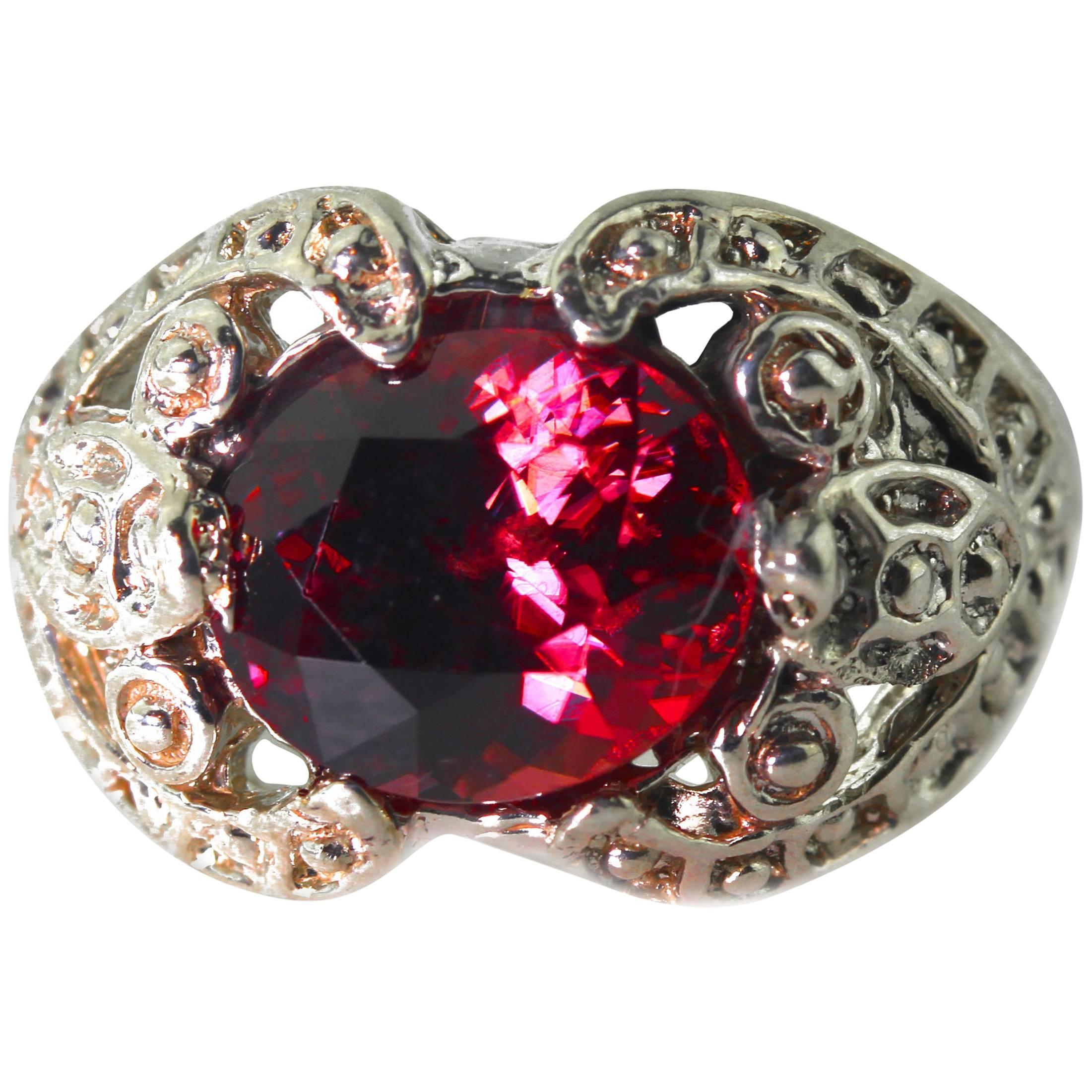 Brilliant glittering rare natural reflective red Zircon (6.4 carats - 10.9 mm x 8.9 mm)) nestled elegantly in a unique handmade beautiful sterling silver ring size 7 (sizable). This goes happily from daytime to evening occasions. It doesn't like its