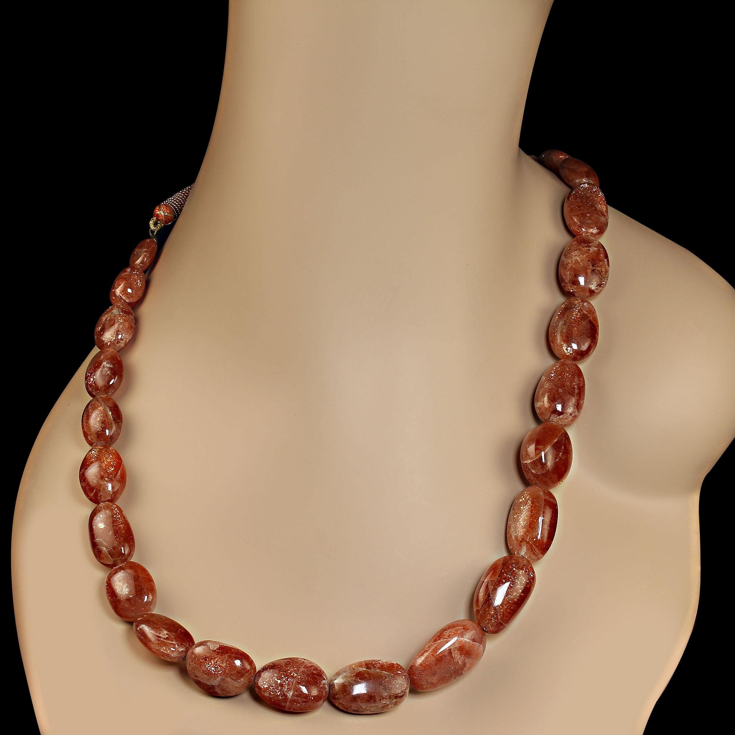 Glorious African sunstone necklace that sparkles and dances in the light. The expandable necklace has 21 inches of graduated, 12 to 25MM, gemstones and then a decorative expandable cord to slide the necklace over your head.  MN2330