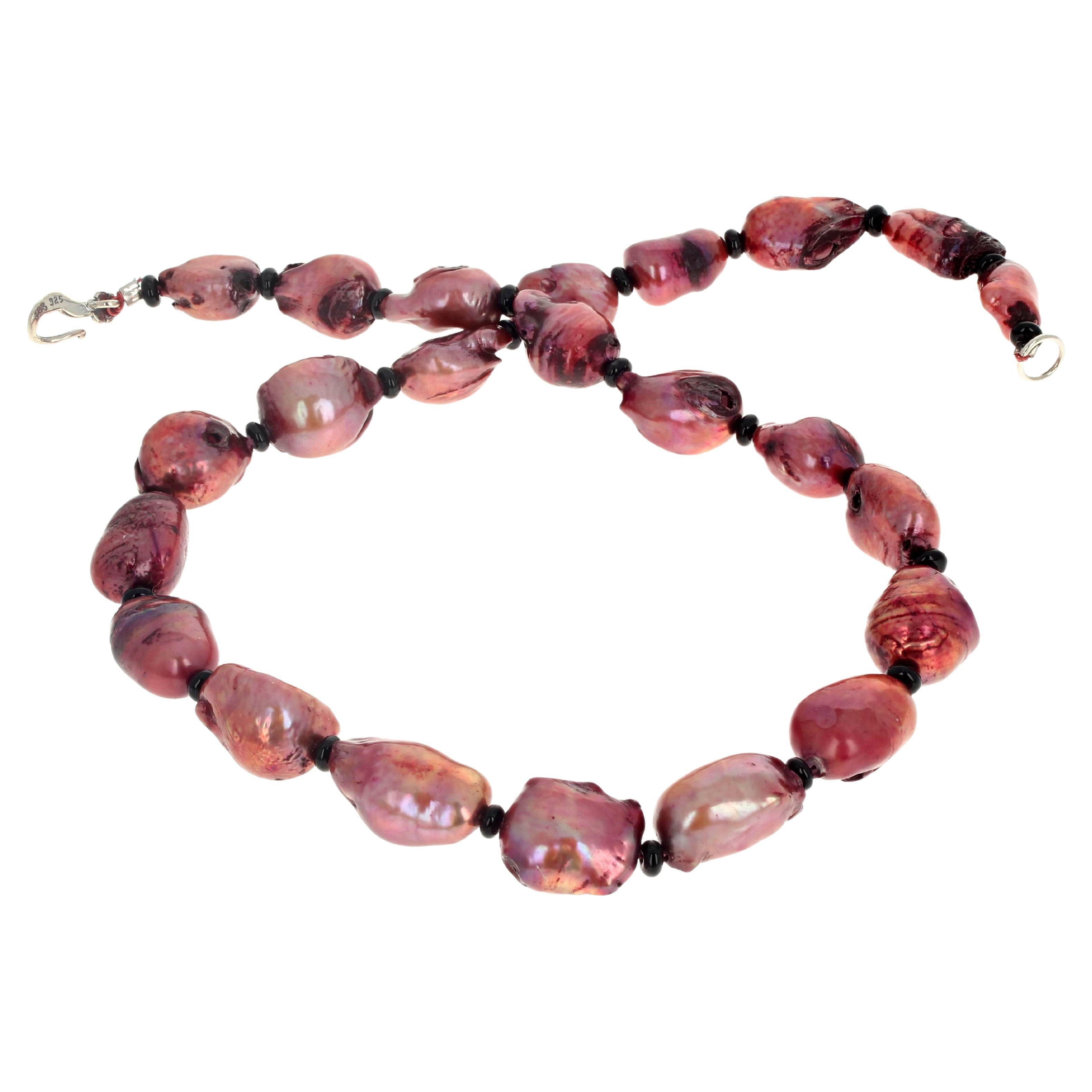 This simple fascinating pinky/coppery cultured Pearl necklace is 17 1/2 inches long.  The largest Pearl is approximately 22mm x 13mm and they are all enhanced by little tiny natural black Onyx rondels.  The clasp is an easy to use silver hook clasp.