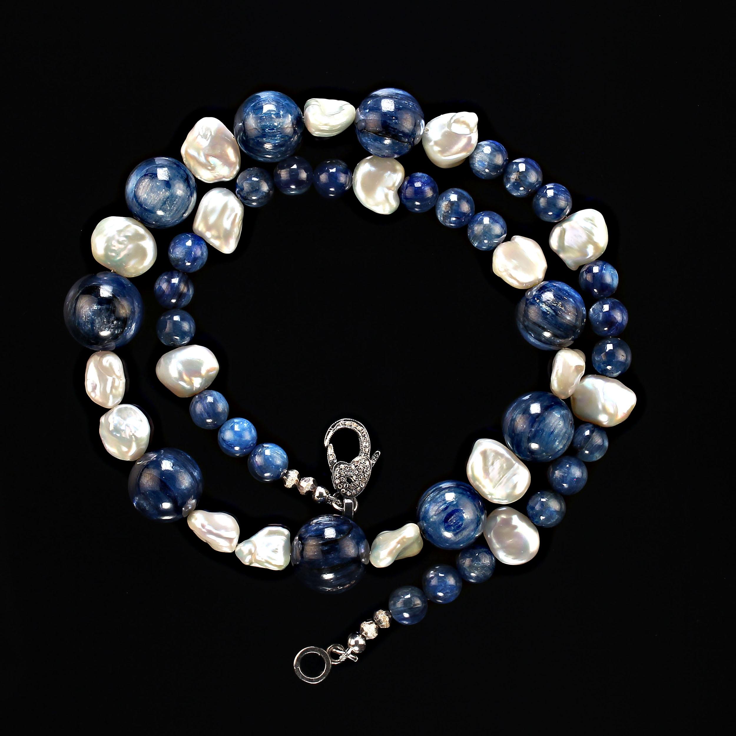 23 Inch Elegant one-of-a-kind necklace featuring two sizes of glowing round kyanite and iridescent white keshi pearls. This gorgeous kyanite has beautiful striations and variations in the best blue of kyanite. They are 16, 14, and 8 MM in size. The