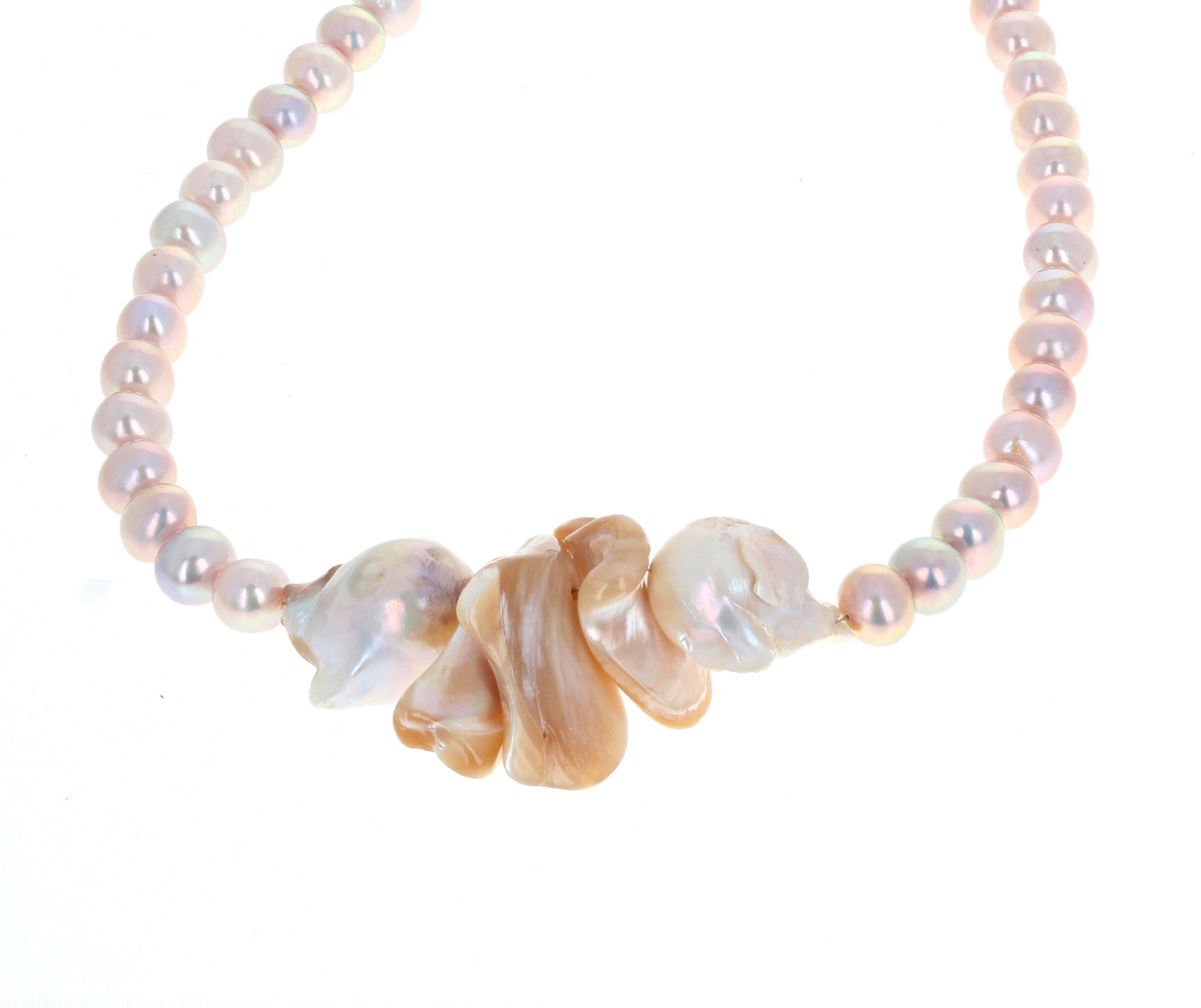 This different dramatic fascinating 20 inch necklace is enhanced by the large gold Pearl shells in the middle of the necklace.   The two large center Pearls are approximately 22mm long x 15mm round.  They are all real Pearls.  The silver clasp is an