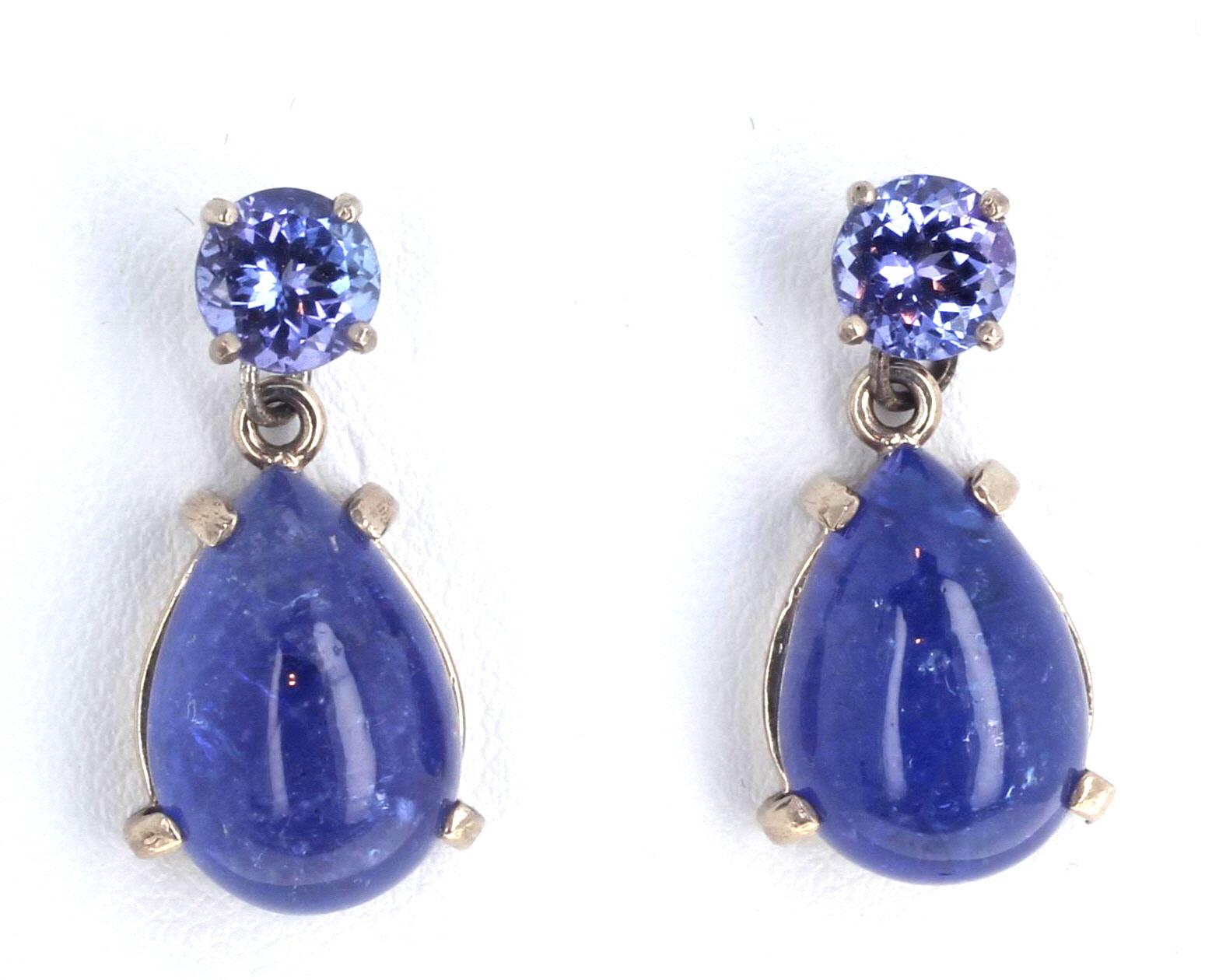 The glittering round natural blue Tanzanites (6mm) dangle natural beautiful blue Tanzanite cabochons (15mm x 11mm) in these white gold earrings.  The total length of the earrings is 26mm.  
