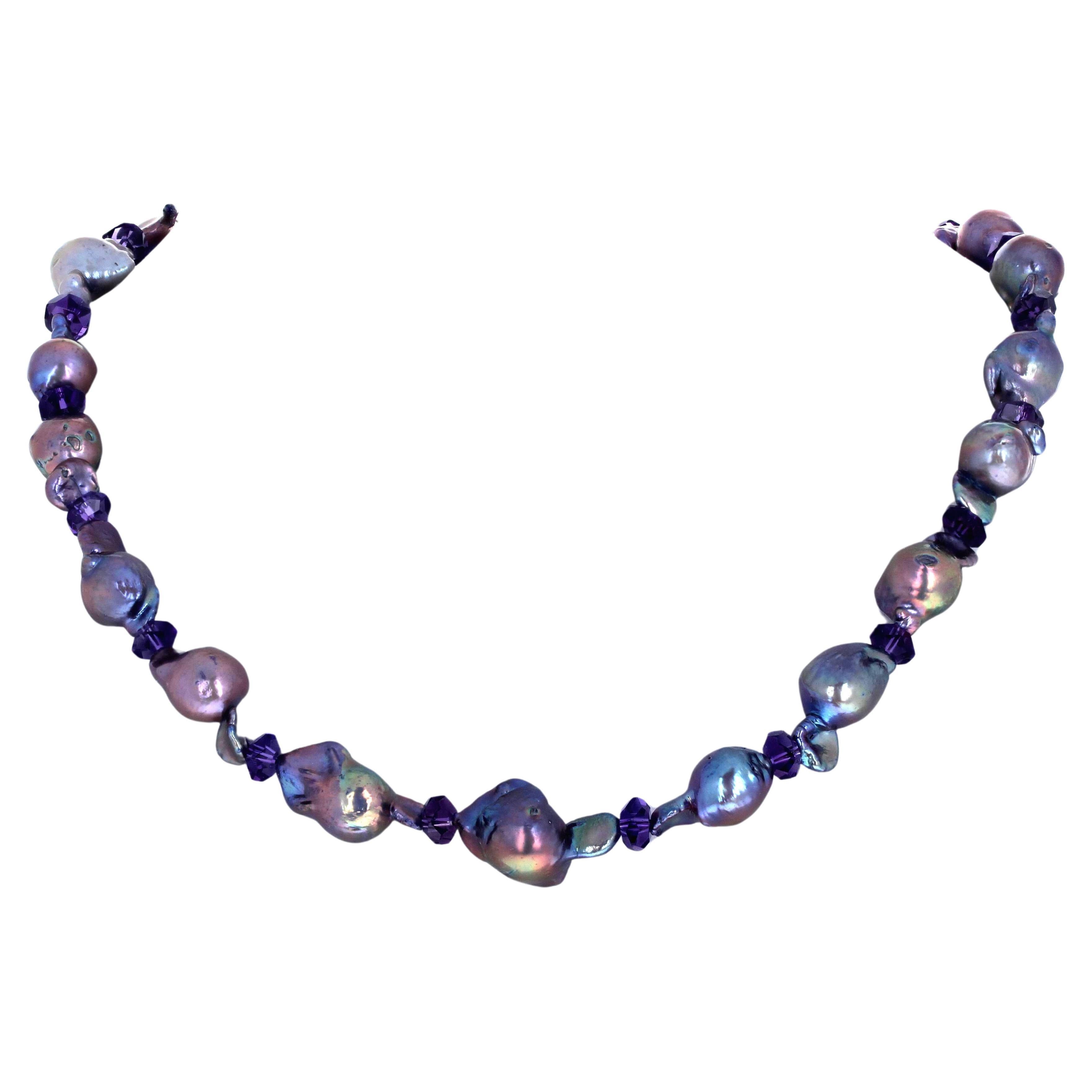 This single strand necklace of real baroque Pearls is 19 inches long.  The largest are approximately 21mm long x 10mm round.  The Pearls are absolutely brilliantly glowingly  enhanced with gem cut real Amethyst gemstone spacers.  The clasp is a