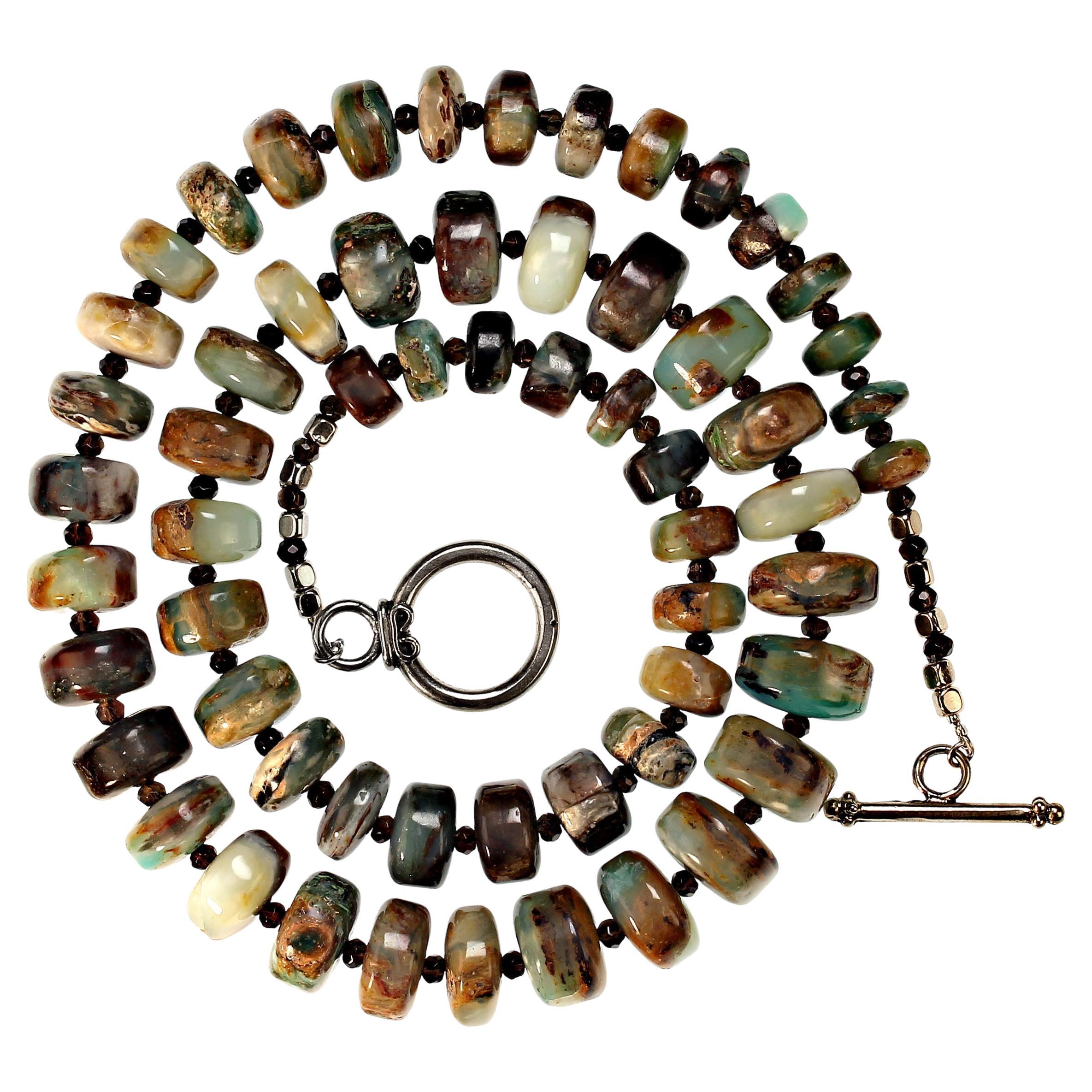 28.5 Inch Graduated Rondels of Highly Polished Peruvian Opal Necklace.  These gorgeous beads are enhanced with sparkling faceted Smoky Quartz. The Peruvian Opal is graduated from 11mm to 16mm.  The Smoky Quartz is 3mm. The necklace is secured with a