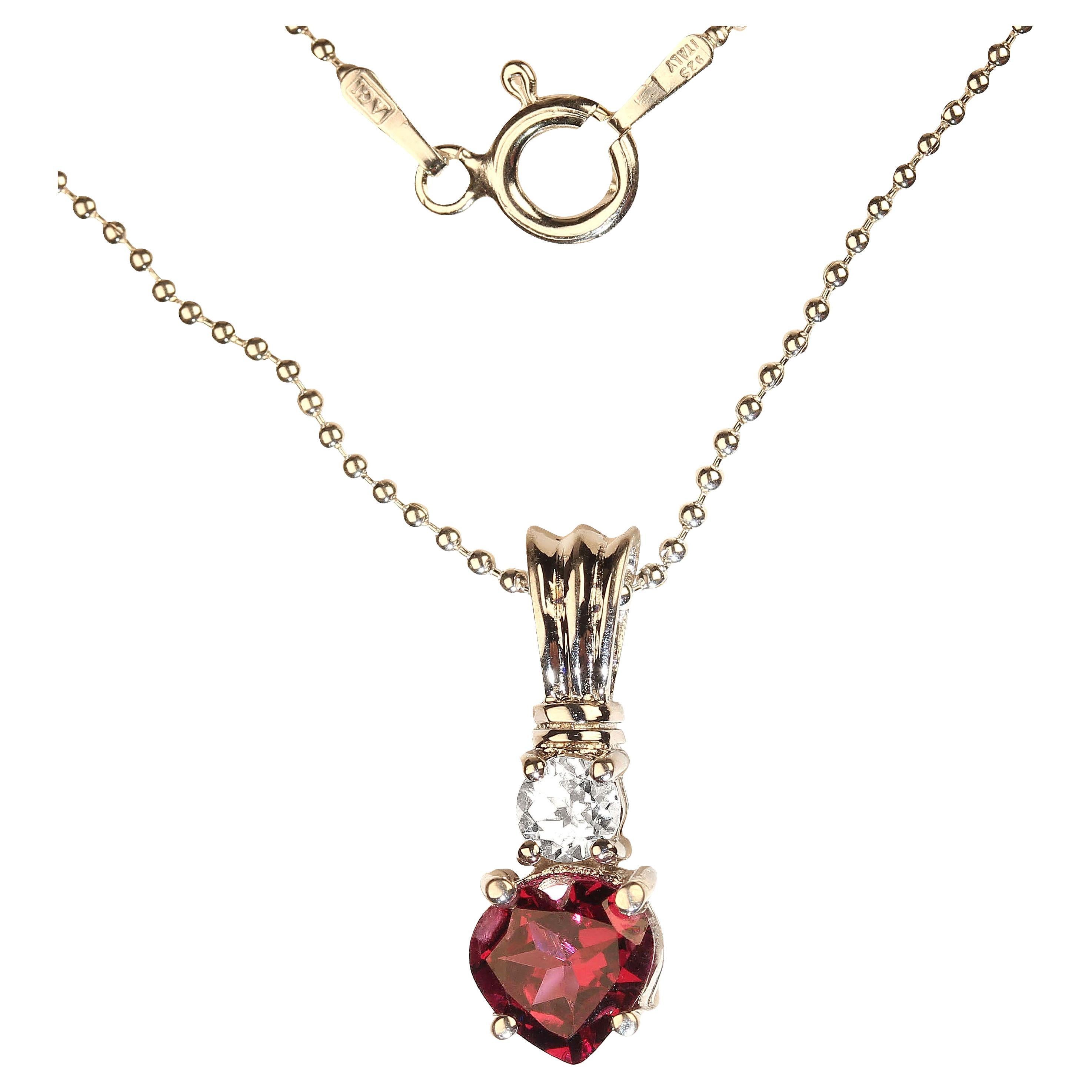 
Sparkling Rhodolite Heart Shape Garnet, 1.21 carats enhanced with real, natural zircon of 0.42 carats in sterling silver pendant. This lovely pendant has the special character of Rhodolites, purply-red flashes! The entire length of the pendant is
