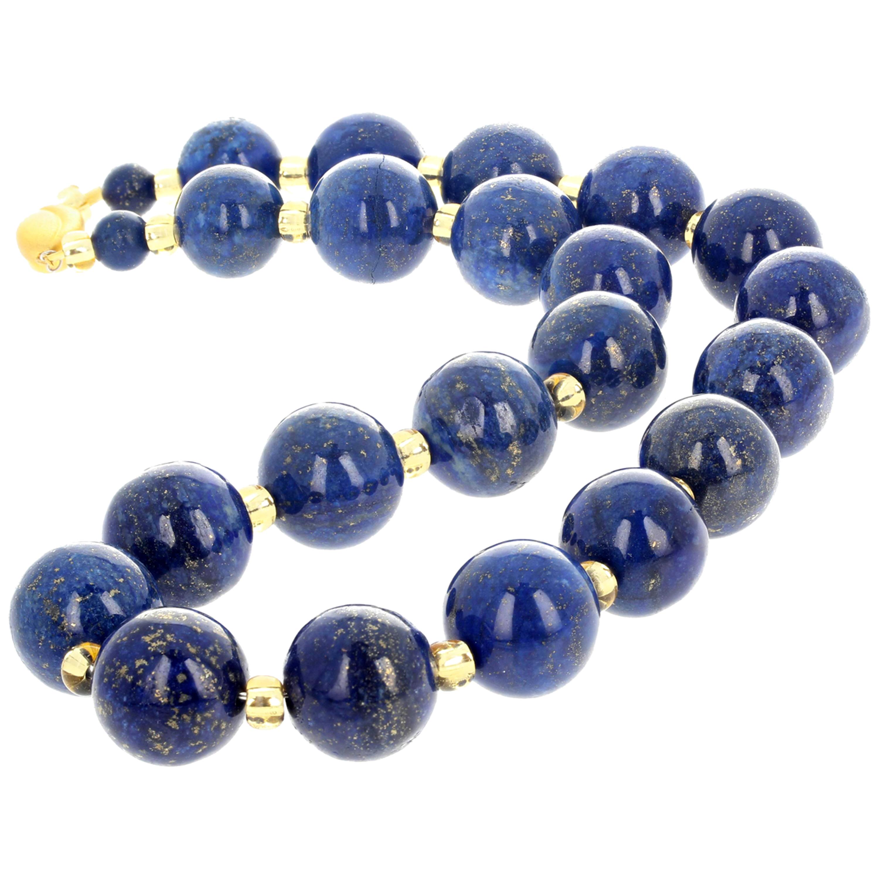 This beautiful highly polished glowing 19.5 inch long Lapis Lazuli necklace is accented with sparkling Czech crystals that enhance the gold reflections in the Lapis gems.  The Lapis are approximately 17 mm and the clasp is gold plated.  If you wish