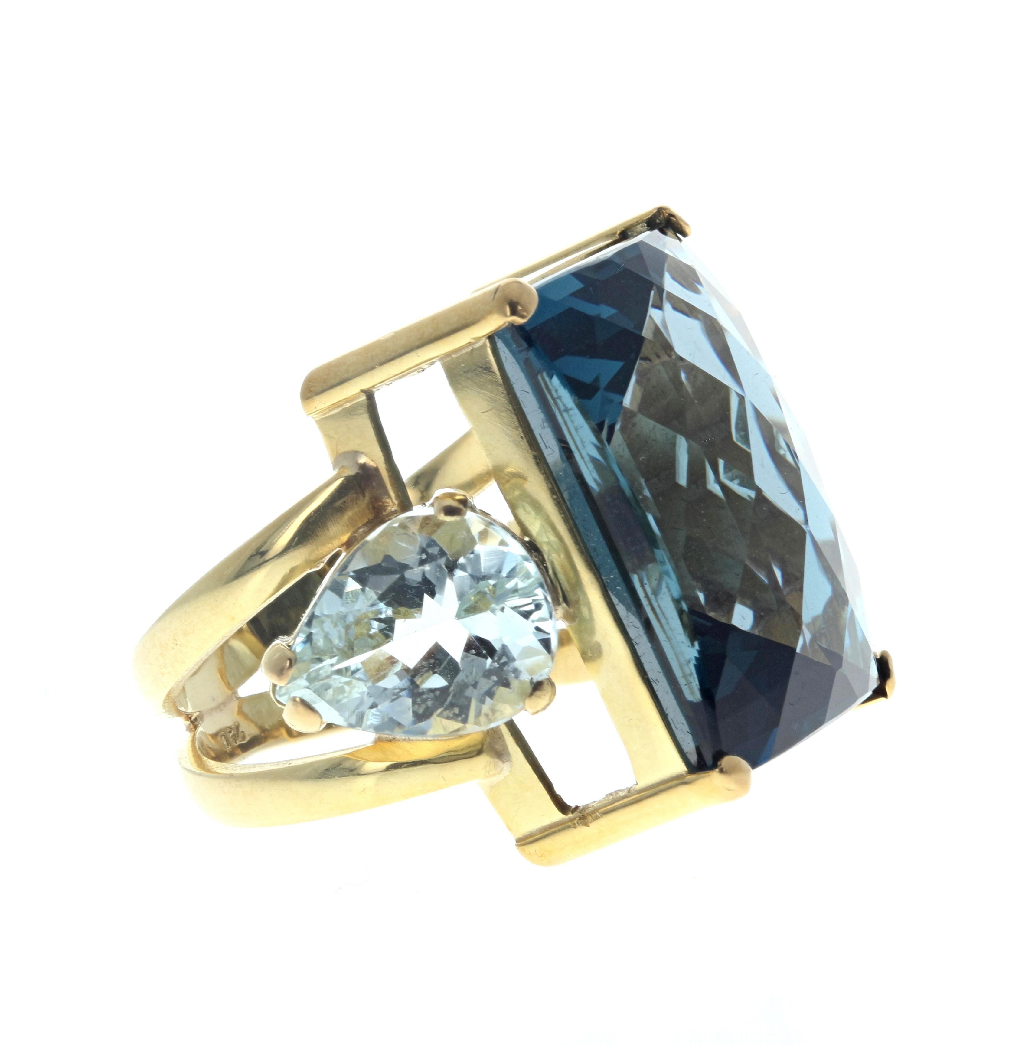 This beautiful real London Blue Topaz is 23 carats and measures approximately  20mm x 15mm.  The beautiful real blue pear shaped Aquamarines are approximately 5 carats each and are approximately 10mm x 18mm.  They are set in a 14KT yellow gold ring