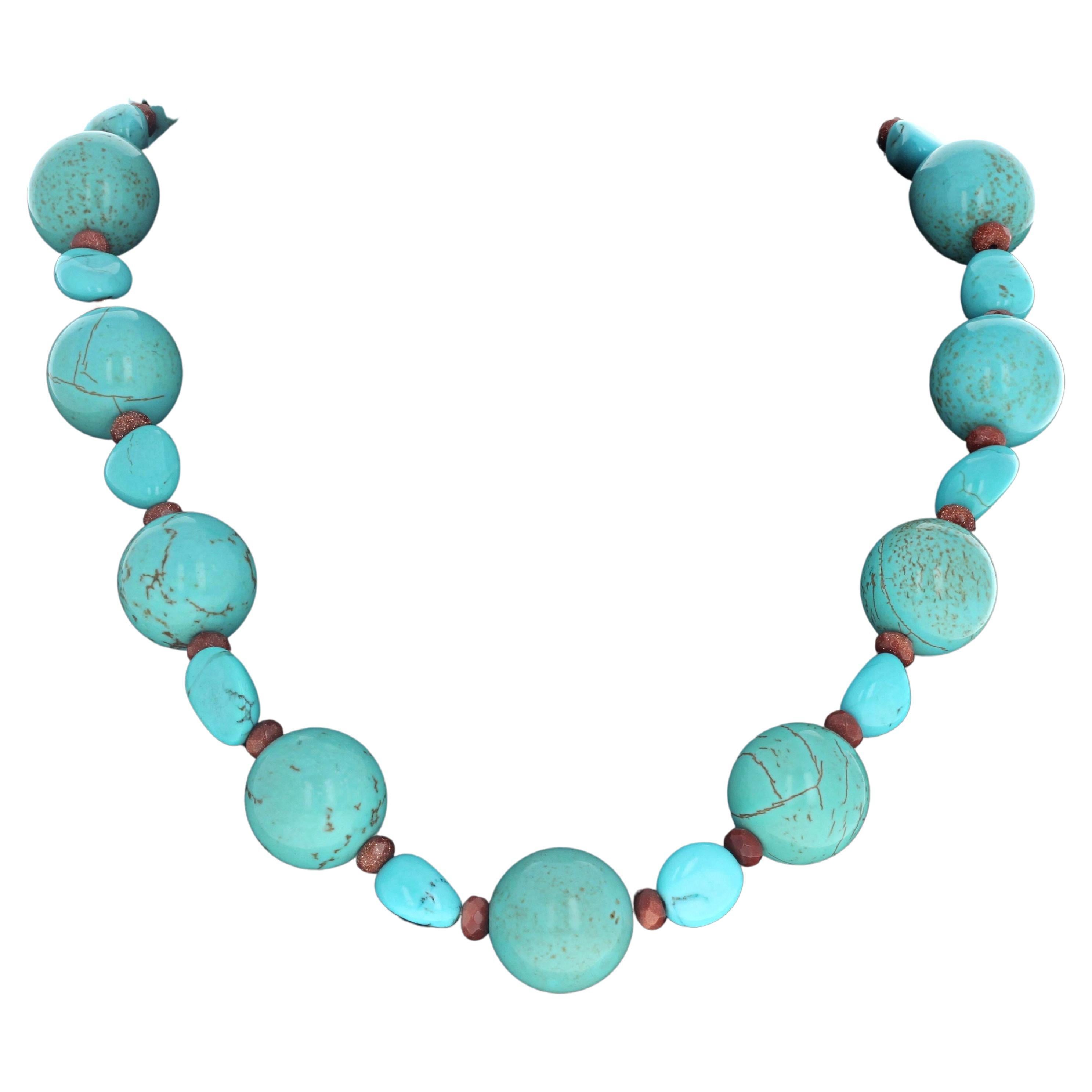 Fascinating combination of big round natural bluegreen Magnesites  (Approximately 19mm) enhanced with highly polished chunks of natural bluegreen Magnesite and little rondels of glowing natural Sunstones.  This necklace is 19 inches long and the