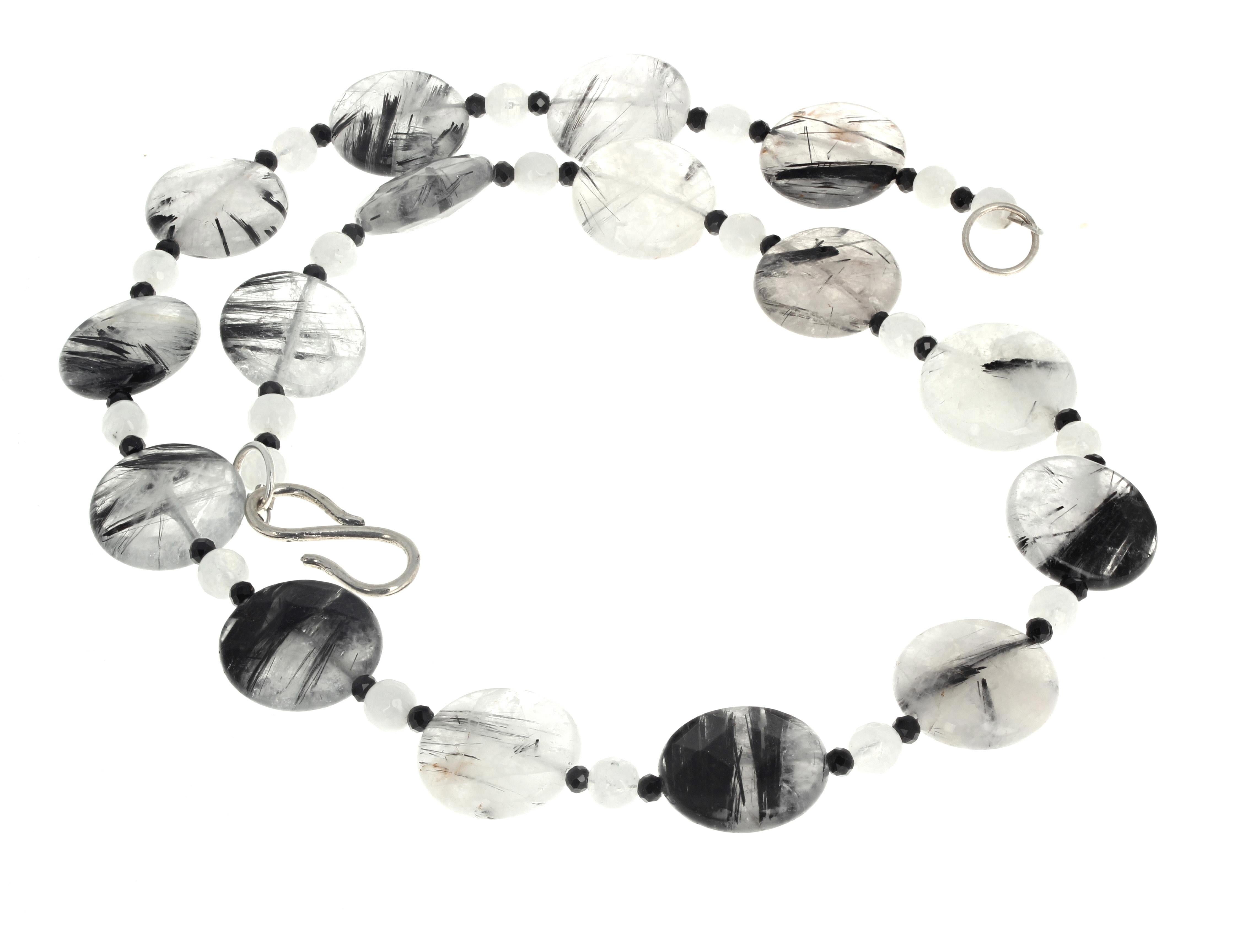 This interesting black and white 18 inch long dramatic necklace is enhanced with round white Quartz gem cut rondels and little black Onyx spacers.  The big round rutilated Quartz are approximately 17mm.  The clasp is a silver easy to use hook clasp.