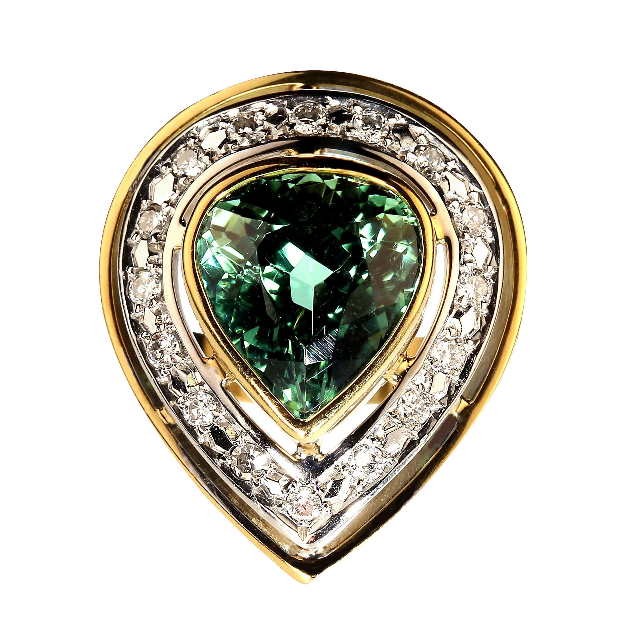 Unique pear shaped blue green Tourmaline ring. This gorgeous ring features a blue green pear shaped Brazilian Tourmaline bezel set in 18K yellow gold.  That is surrounded with a band of 18K white gold pave set with diamonds. It is encircled with