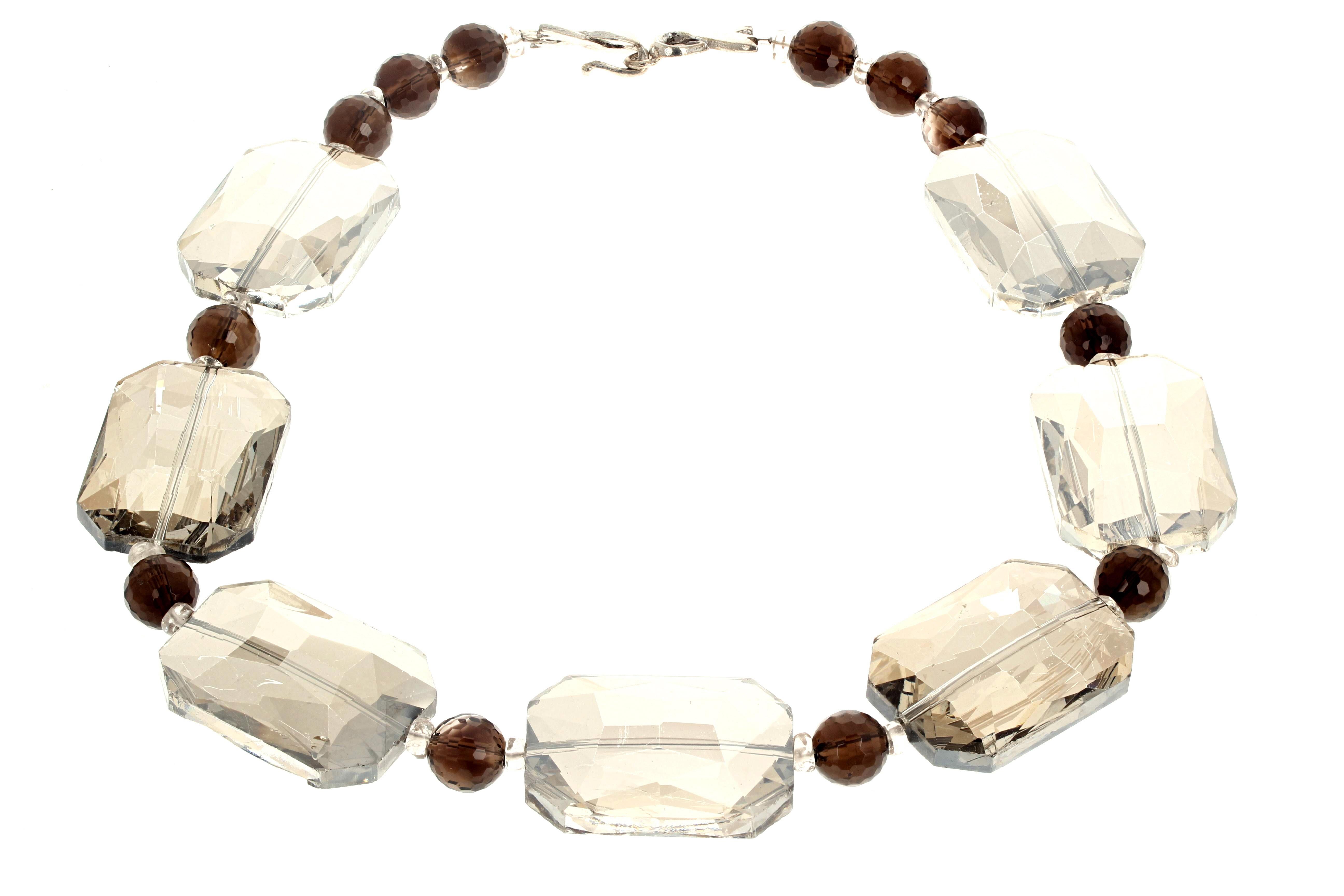 This fascinating necklace is 17 inches long and is composed of large Mystic Quartz (35mm x 24mm) enhanced with sparkling gem cut natural 10mm Smoky Quartz.  This has an easy to use silvery hook clasp.  (Mystic quartz is natural real cut quartz which