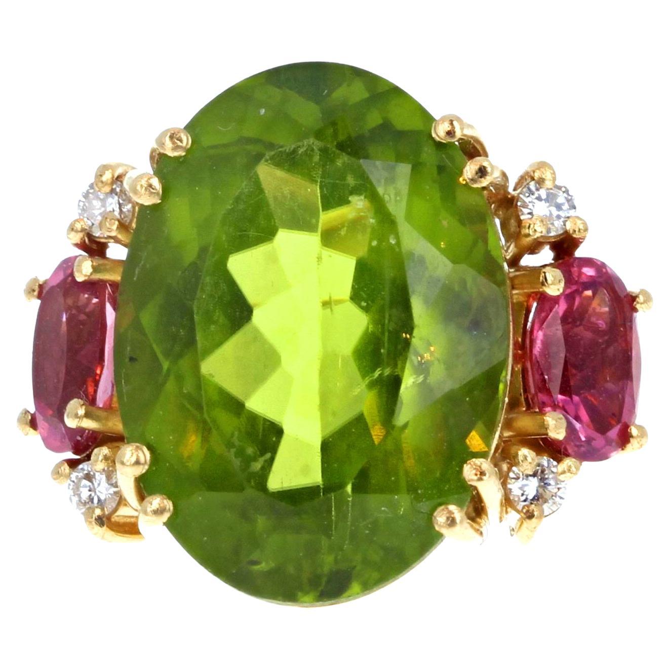 This 18Kt yellow gold ring holds a 14 carat natural clear green Tourmaline enhanced with 4 tiny white sparkling glittering little Diamonds and Pink Tourmalines.  The main Tourmaline gemstone is 18mm x 13.2mm and is intensely green.  The Pink