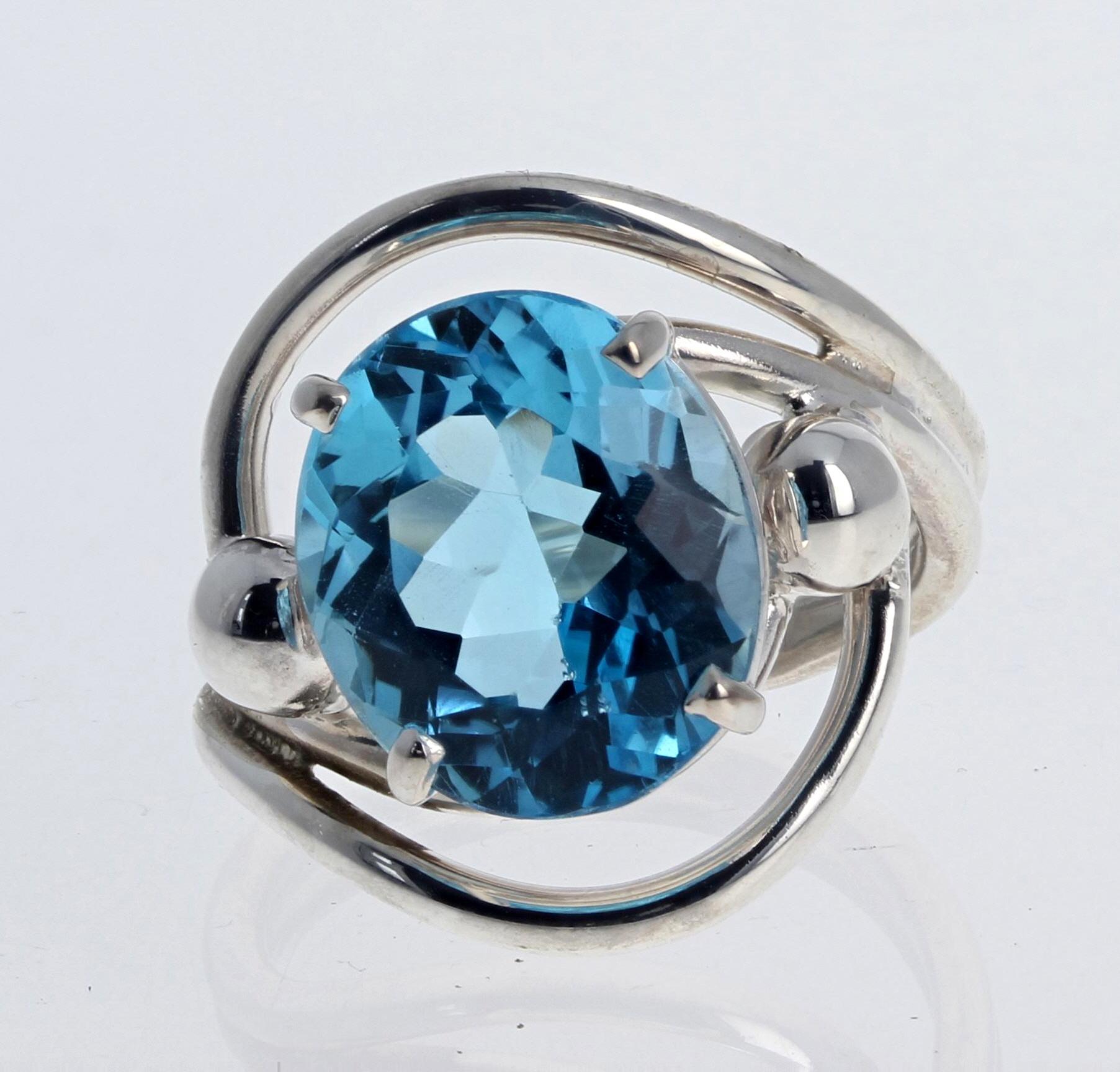 Glittering beautiful blue Topaz ring.  This measures 14.2mm x 12mm and is 10.26 Carats.  It is intensely blue with no eye visible inclusions. and is set dramatically up on a sterling silver designer ring size 9 (sizable).  
