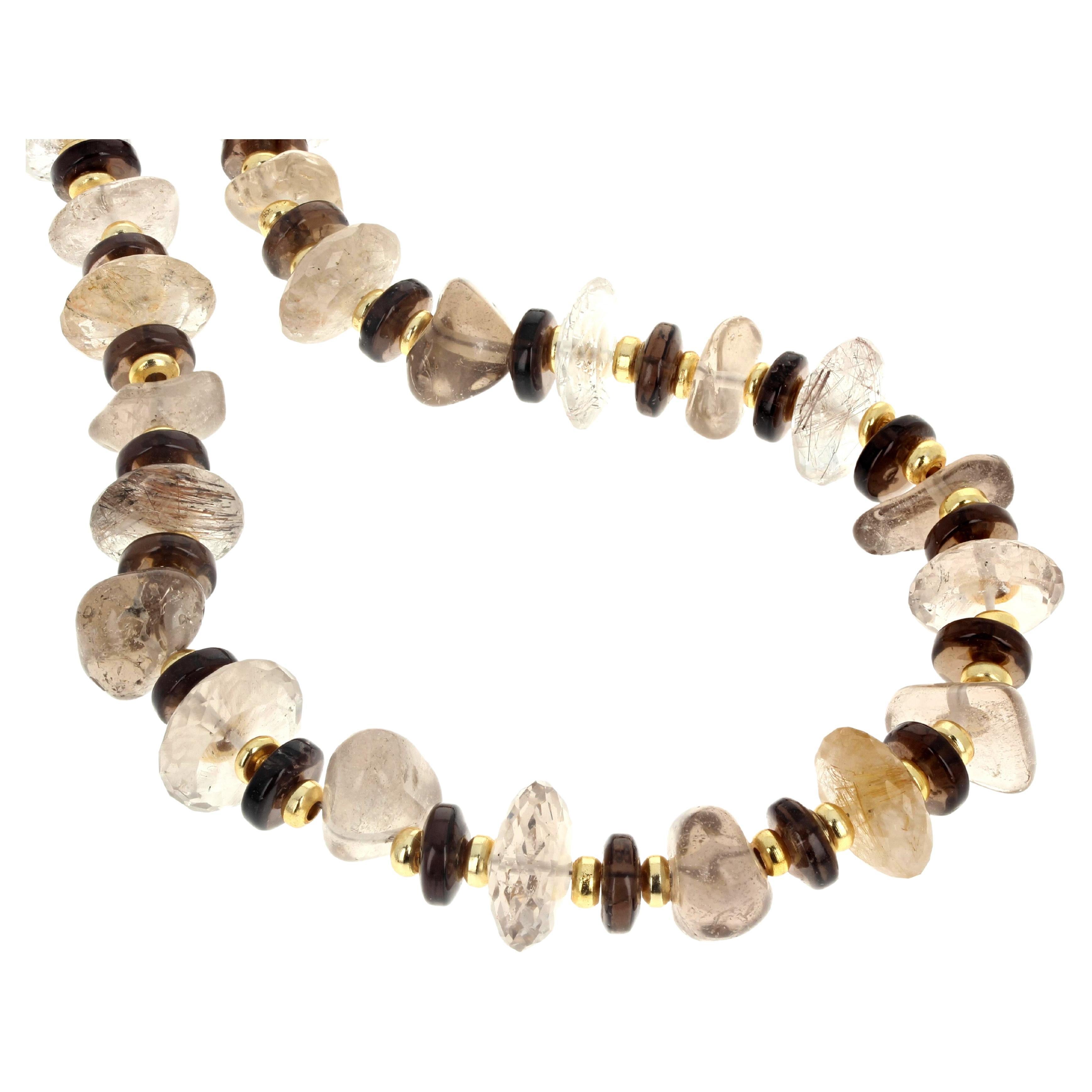 This fascinating delightful natural Smoky Quartz necklace is 18 inches long.  It is composed of several different colors, purities and intensities of Smoky Quartz in different cuts but all are polished.  It is enhanced with tiny little round gold