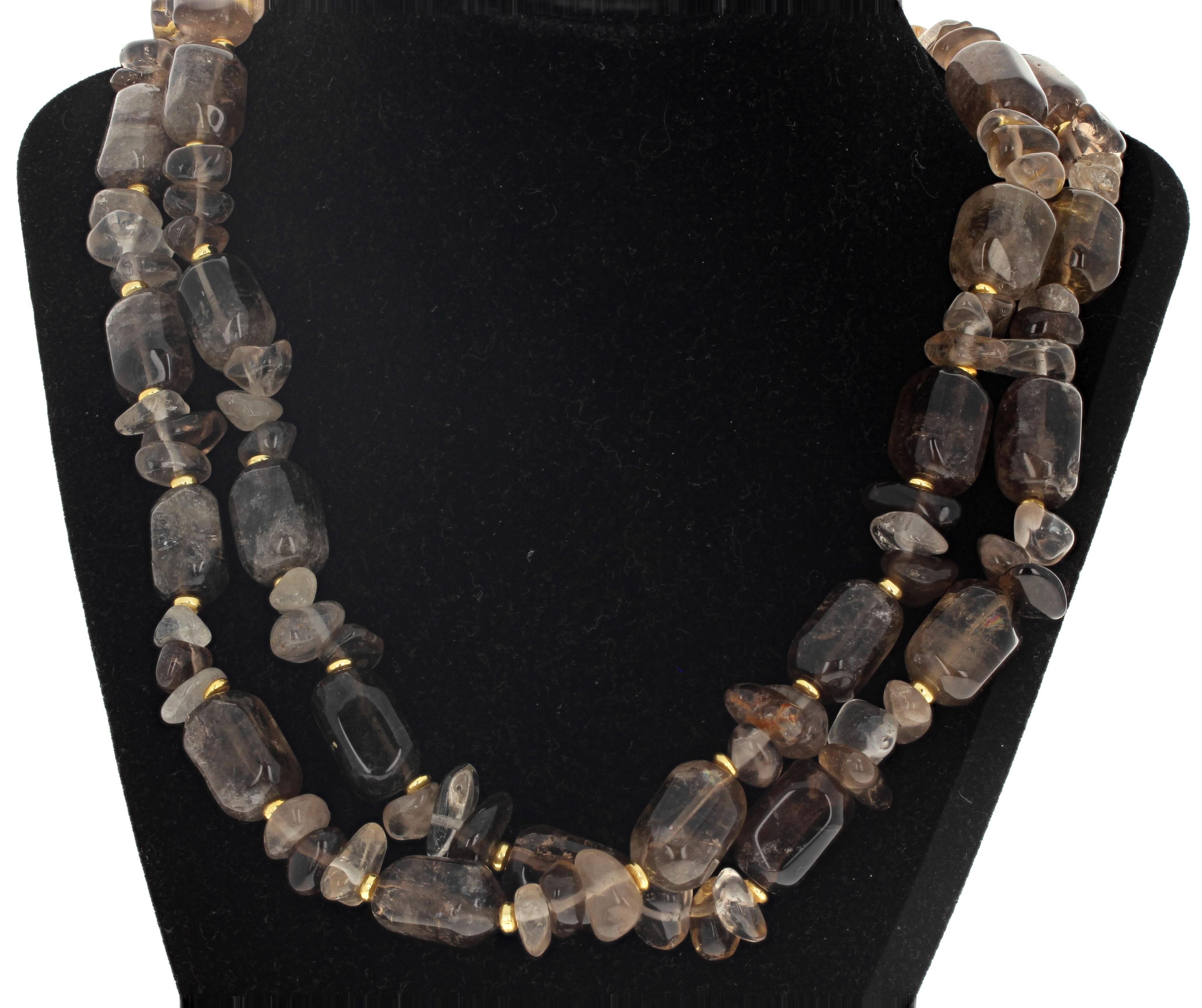 All of these highly polished brightly glowing natural Smoky Quartz compose this 19 1/2 inch long necklace.  The largest ones are approximately 18mm x 12mm and are lightly enhanced by tiny little round gold plated rings.  The clasp is an easy to use