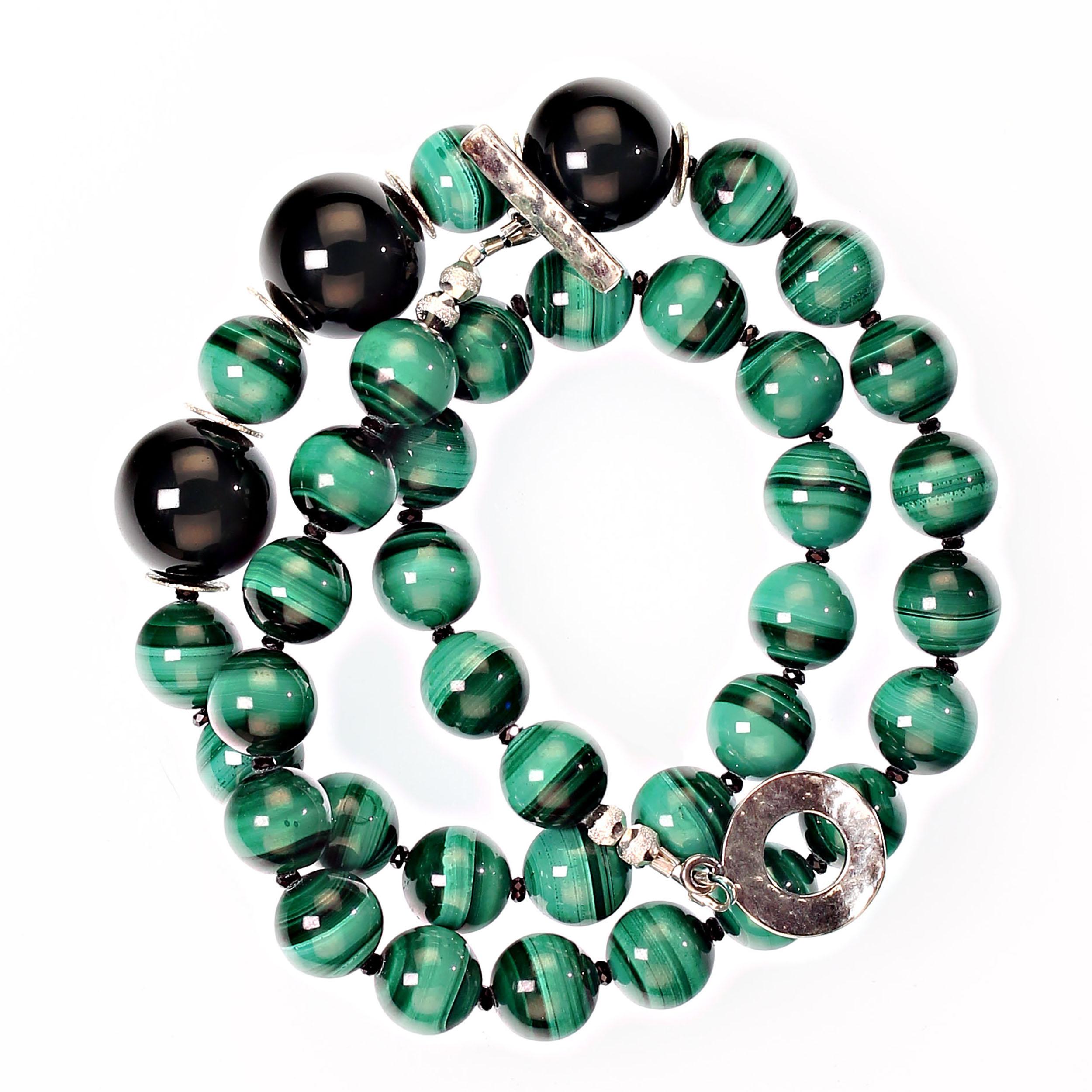 20 Inch magnificent Malachite necklace accented with black Spinel and black Onyx.  The 10MM beautifully banded smooth Malachite is separated by the sparkling faceted black Spinel. Three 15 MM smooth black Onyx are focal across the front of this