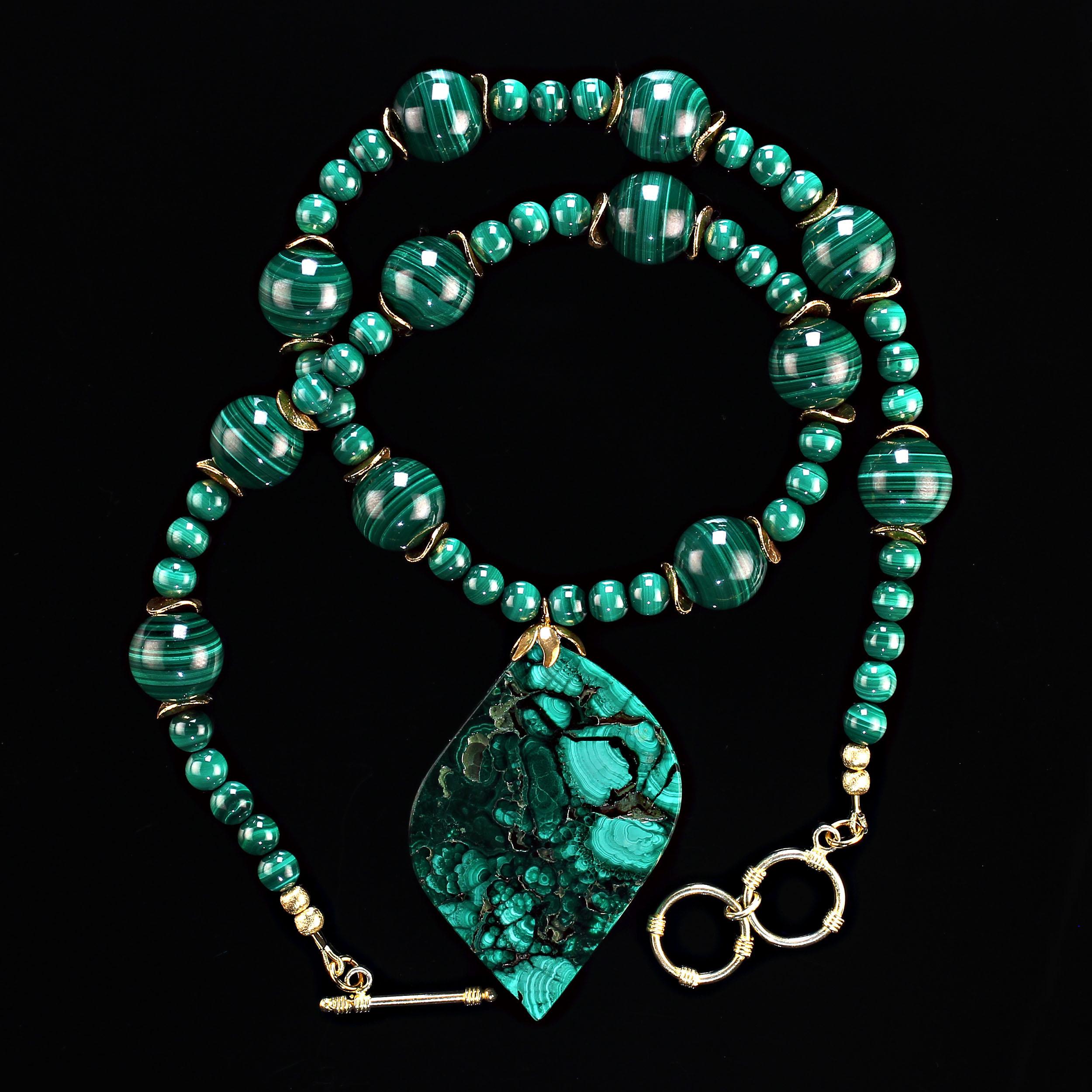 22 Inch necklace of fabulous malachite in 16MM and 6MM smooth rounds with gold tone flutters.  The free form malachite pendant is 2.25 x 1.50 inches. The 22 inch necklace is secured with a gold-plate two ring toggle clasp.  MN2350