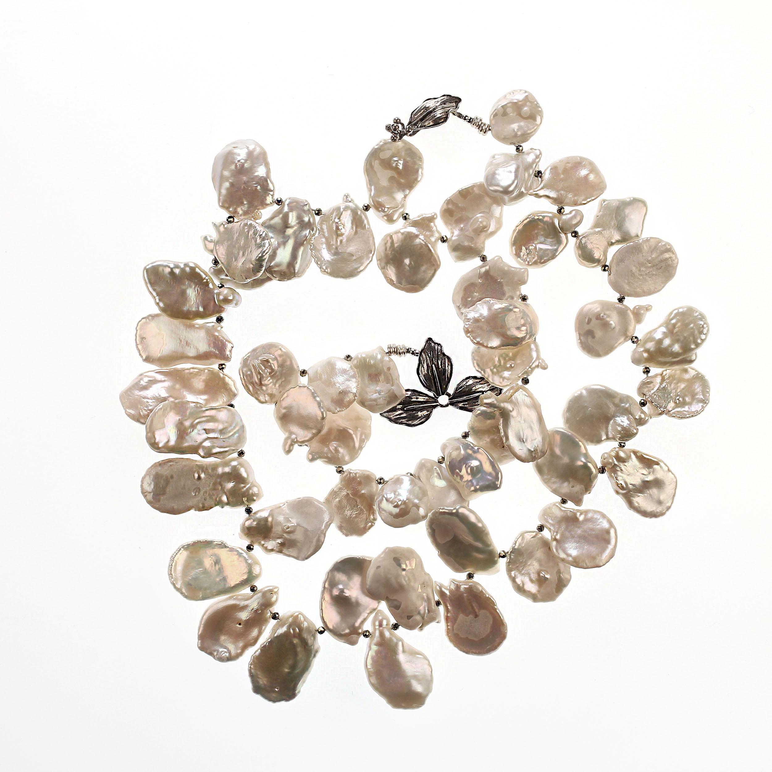 'Pearls are always appropriate.'  Jackie Kennedy

Custom made, graduated Keshi Pearls, 15-20mm, fluttering along a matinee length necklace with pyrite accents. These Keshi Pearls have some beauty marks. However,they are all iridescent, flashing