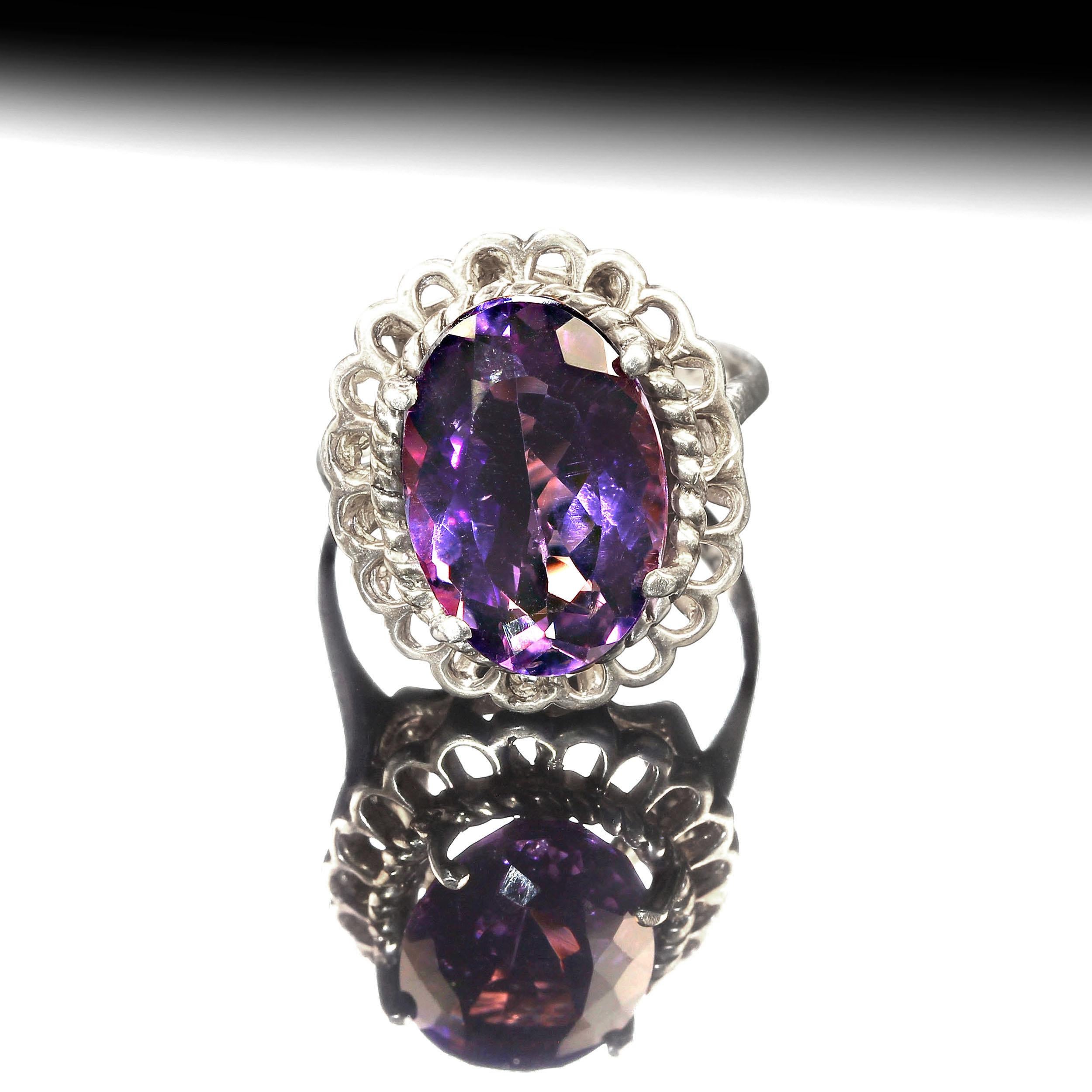 Custom made, sparkling oval Amethyst Ring. This lively Amethyst has delightful pink flashes and is set in a lovely detailed high basket setting of Rhodium over Sterling Silver Ring. This setting has a twisted rope detail next to the amethyst and the
