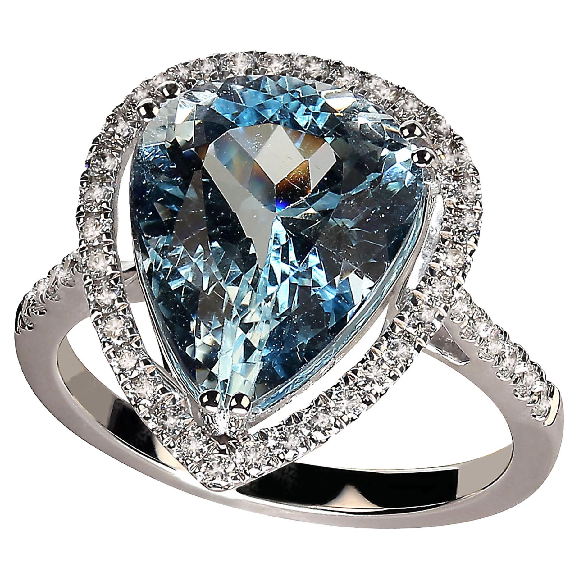 Glittering pear shape, 5.32ct Aquamarine in Diamond halo ring.  This one of a kind ring is breathtaking. It sparkles and dances on your finger.  The delicate Diamond halo enhances the beautiful blue Aquamarine and  Diamonds continue sparkling all