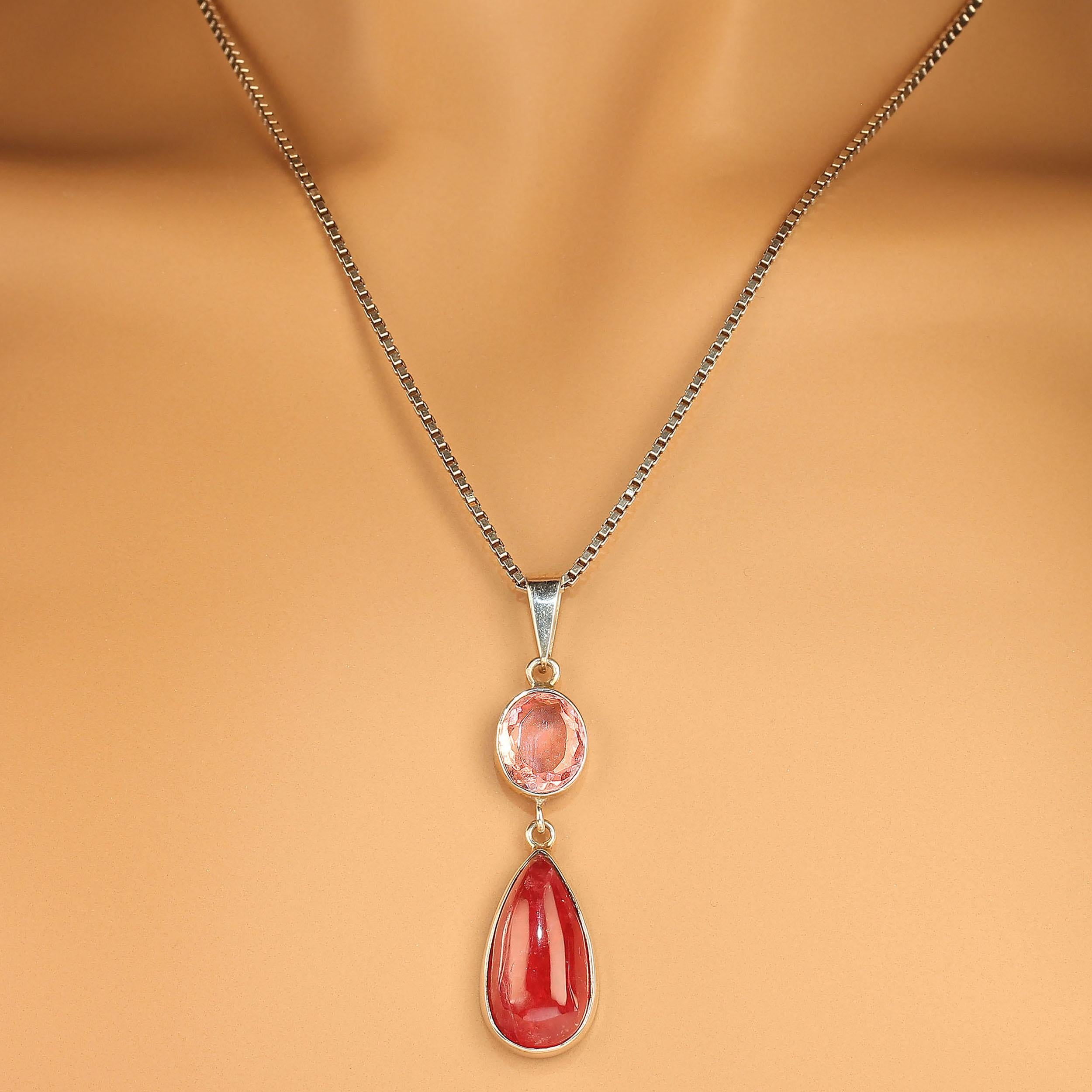 This unique two stone pendant features an oval pink tourmaline of 3.35 carats above a long teardrop shape deep pinky/red rhodonite of 13.64 carats. These two gemstones are hinged together and the total length of the pendant is 2 inches. It is