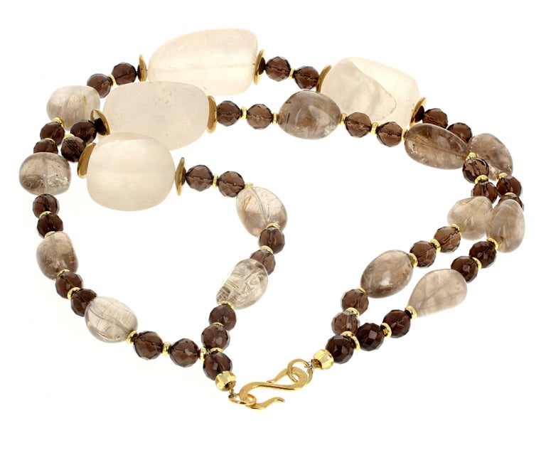 Fascinating interesting huge highly polished chunks of natural light Rutilated Quartz are enhanced by the brilliant natural gemcut and polished Smoky Quartz.  The clasp is a gold plated easy to use hook clasp in this 17 inch long necklace.  The big