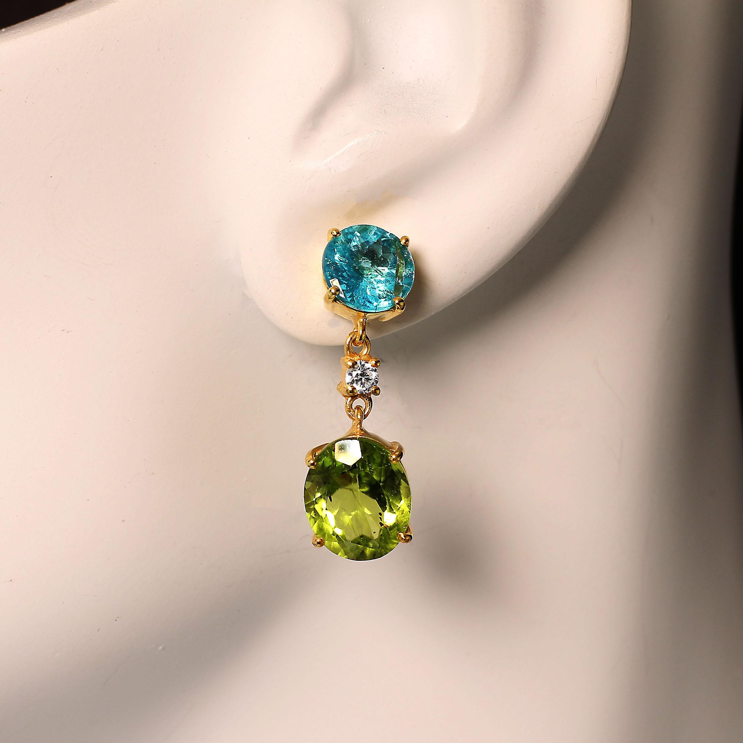 Wear these sparkling earrings for day and night. They are bright and fun. Shining oval Peridot hang from brilliant round bright blue Neon Apatite with a Cambodian Zircon in betweeen at the hinge. These earrings swing and dance as you move your head.