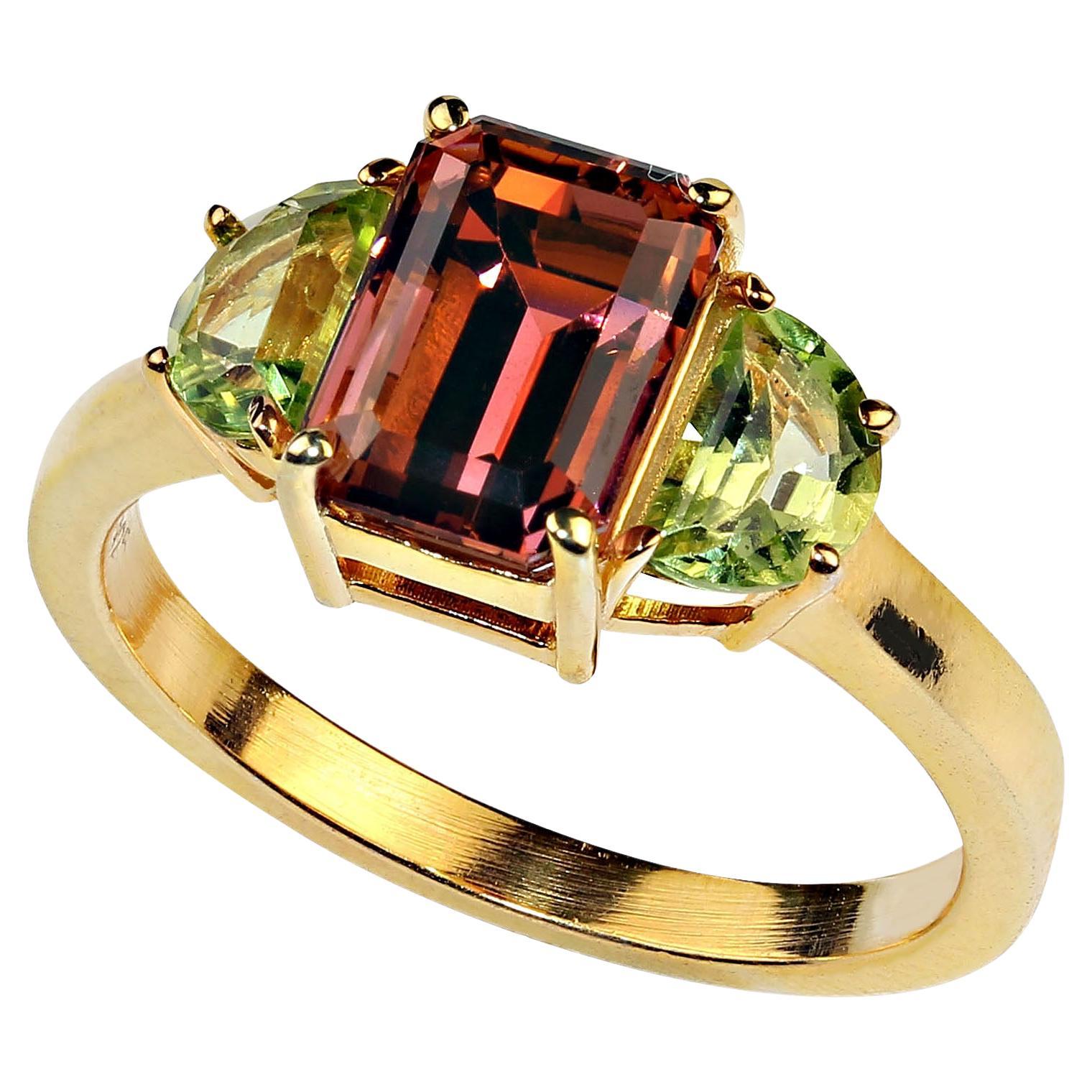 Rare and unusual orange Tourmaline accented with twin half moon Peridot set in gold rhodium over Sterling Silver ring.  This gorgeous, clean, sparkling Tourmaline is that fantastic orange shade that is so covented.  This is a 2.70ct beauty straight