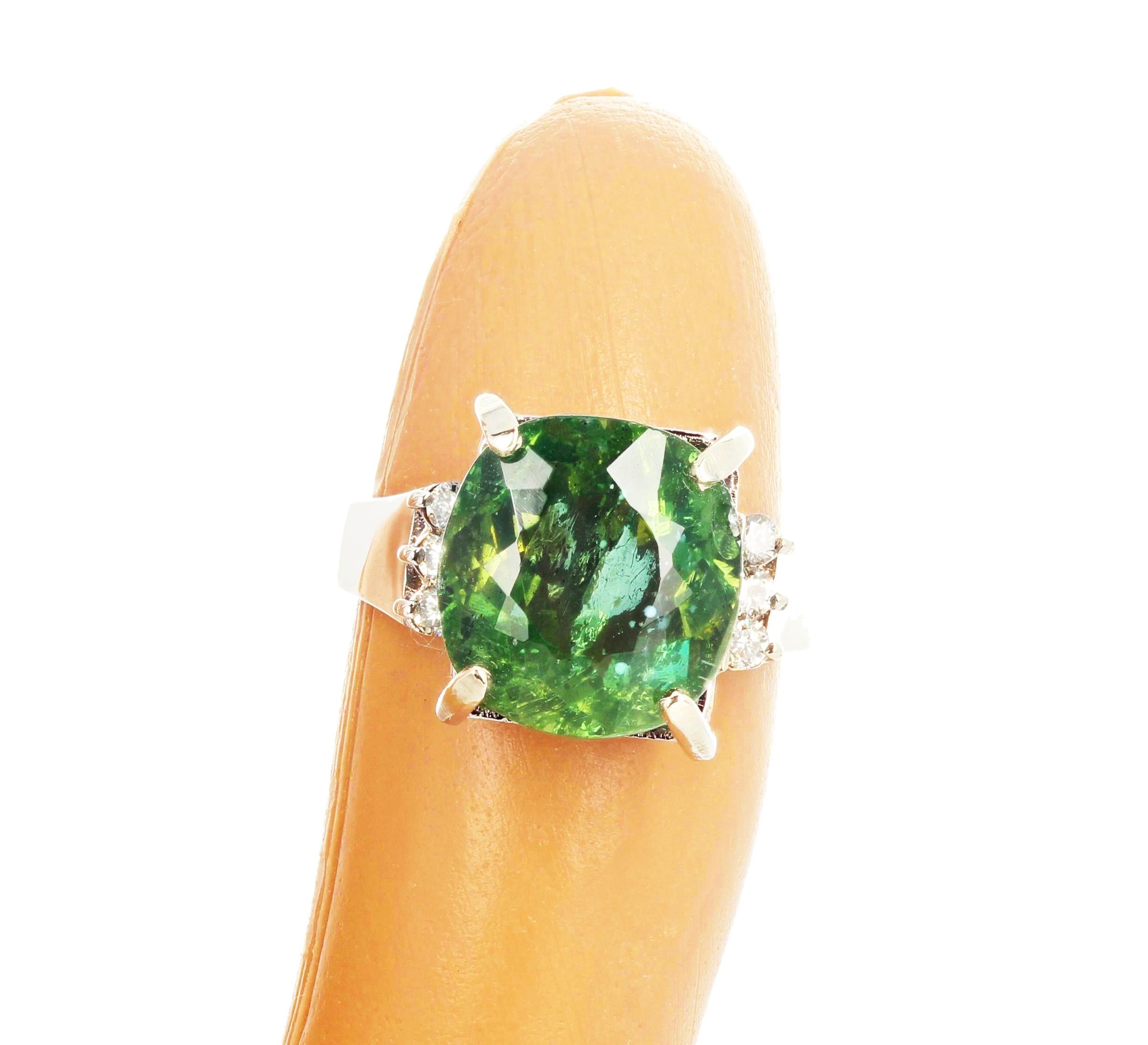 This 8 Carat cushion cut glittering brilliant natural green Madagascar Apatite (12.5mm x 11.9 mm) is enhanced with 6 beautiful sparkling diamonds set in a lovely 14KT white gold ring size 7 (sizable). Spectacular optical effect in the Apatite