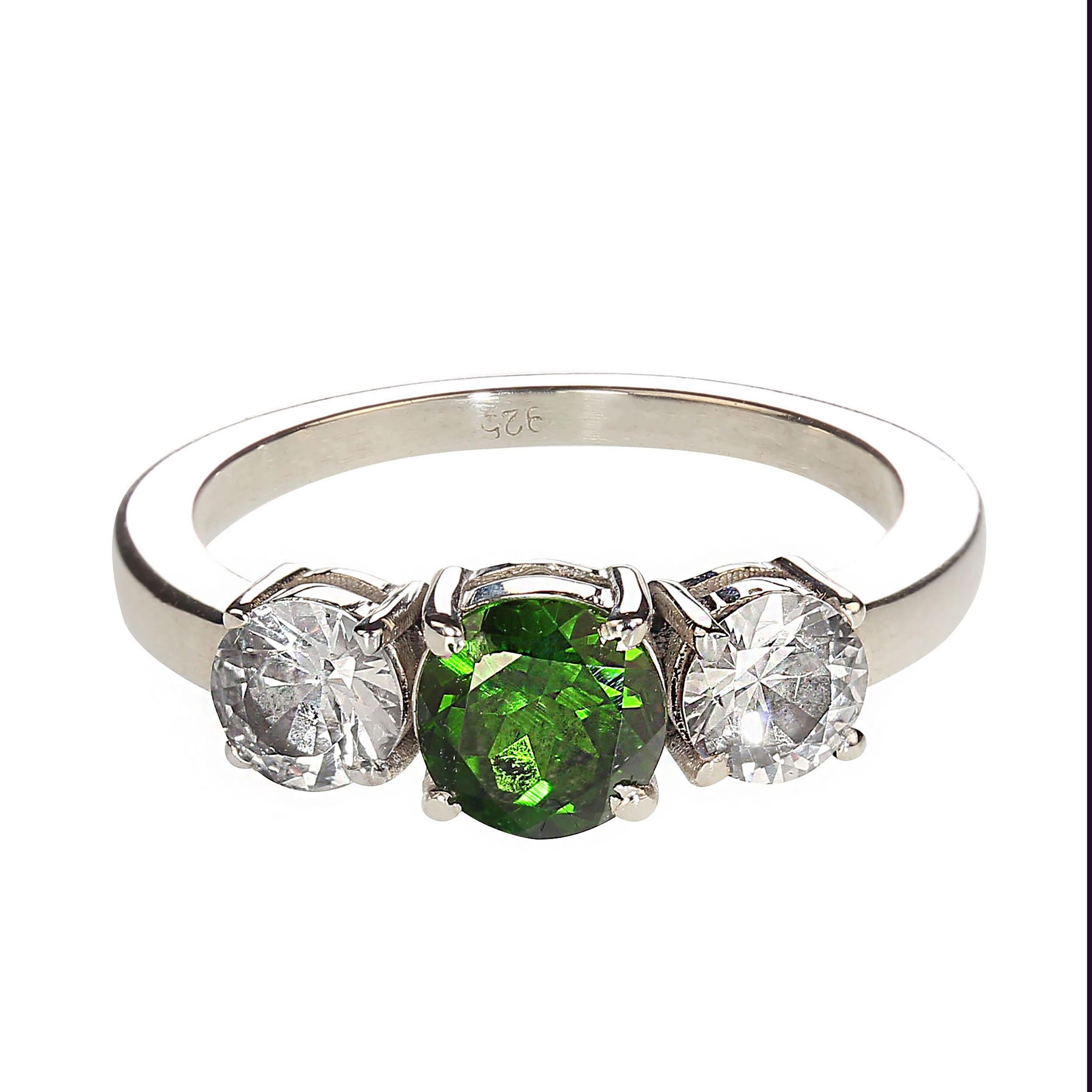 Sparkling rare green Demantoid Garnet accented by two white Sapphires, set in a Sterling Silver Classically designed ring.  The garnet weighs 1.15cts.  The white white sapphires total weight 1.06cts. No changes by seller.  This is a sizable 8.25.