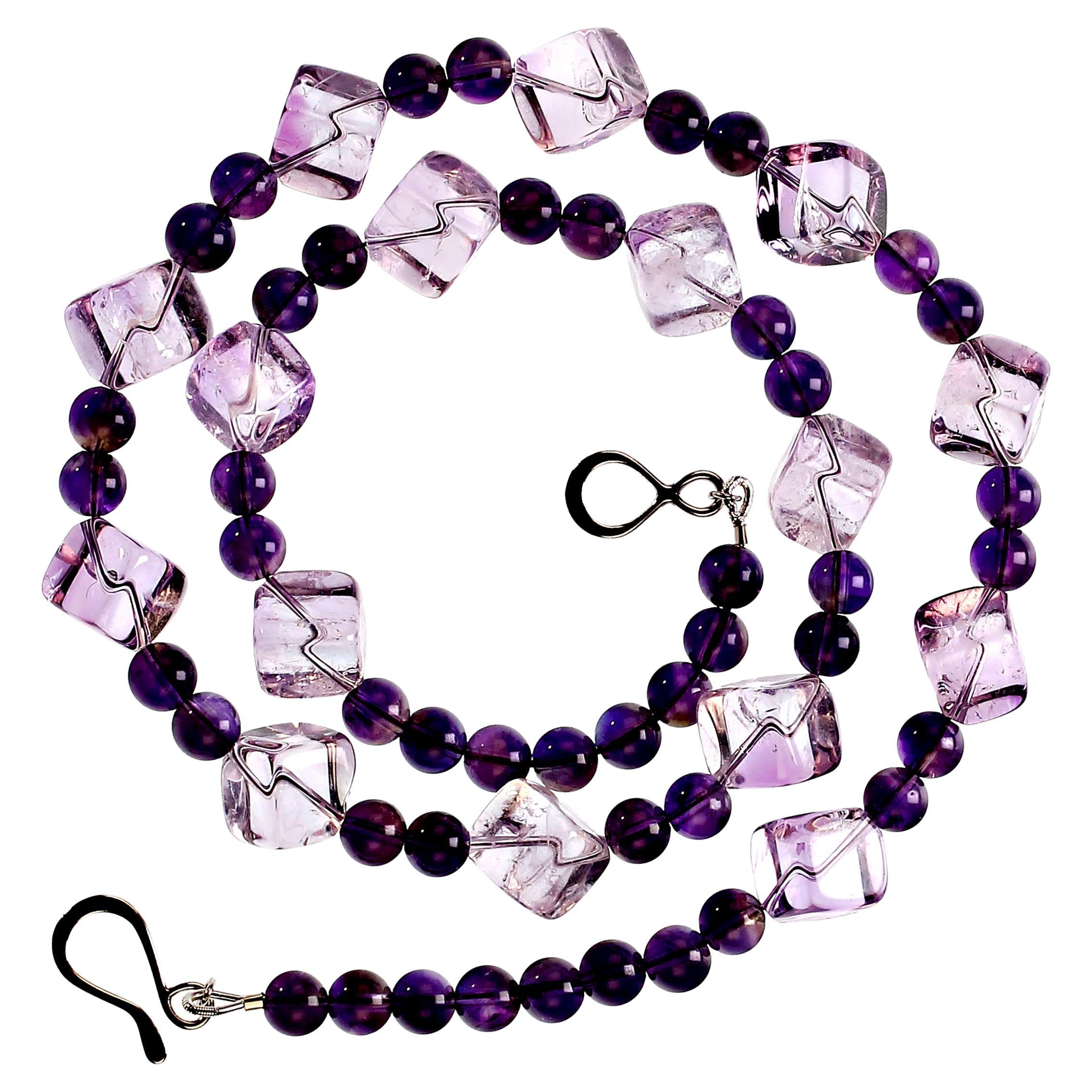 Shades of Amethyst create this unique and gorgeous 21-inch necklace.  The beautifully polished 10mm cubes of rose of france and accented with 6 mm darker amethyst and secured with a sterling silver hook and eye clasp.  MN2342